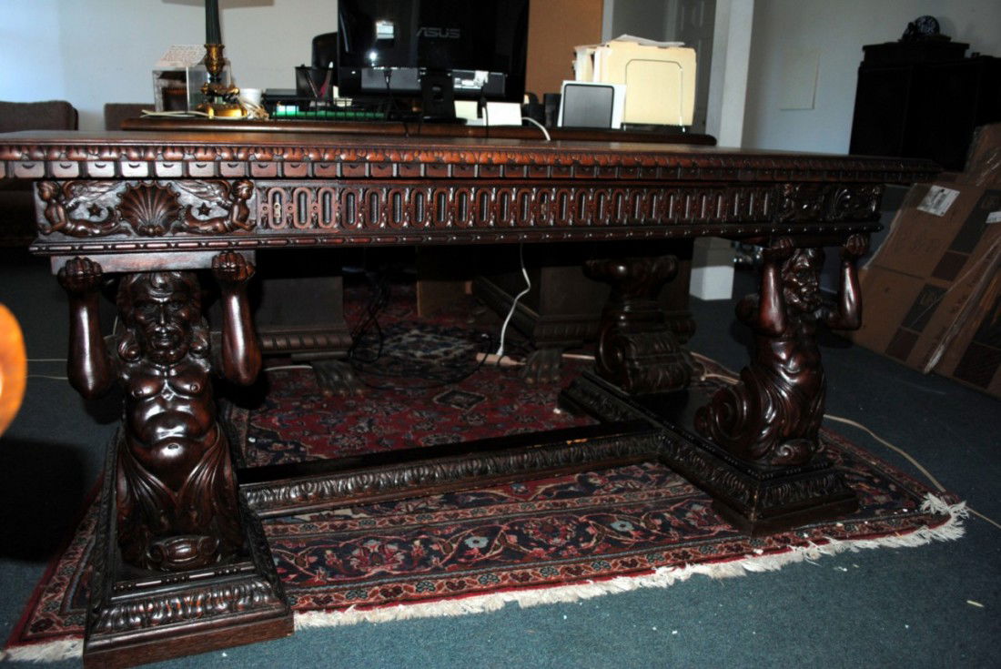 German Man of the Mountain Desk: Intricate carvings. 1900's German antique walnut desk. Measures: 33"x66"x31"