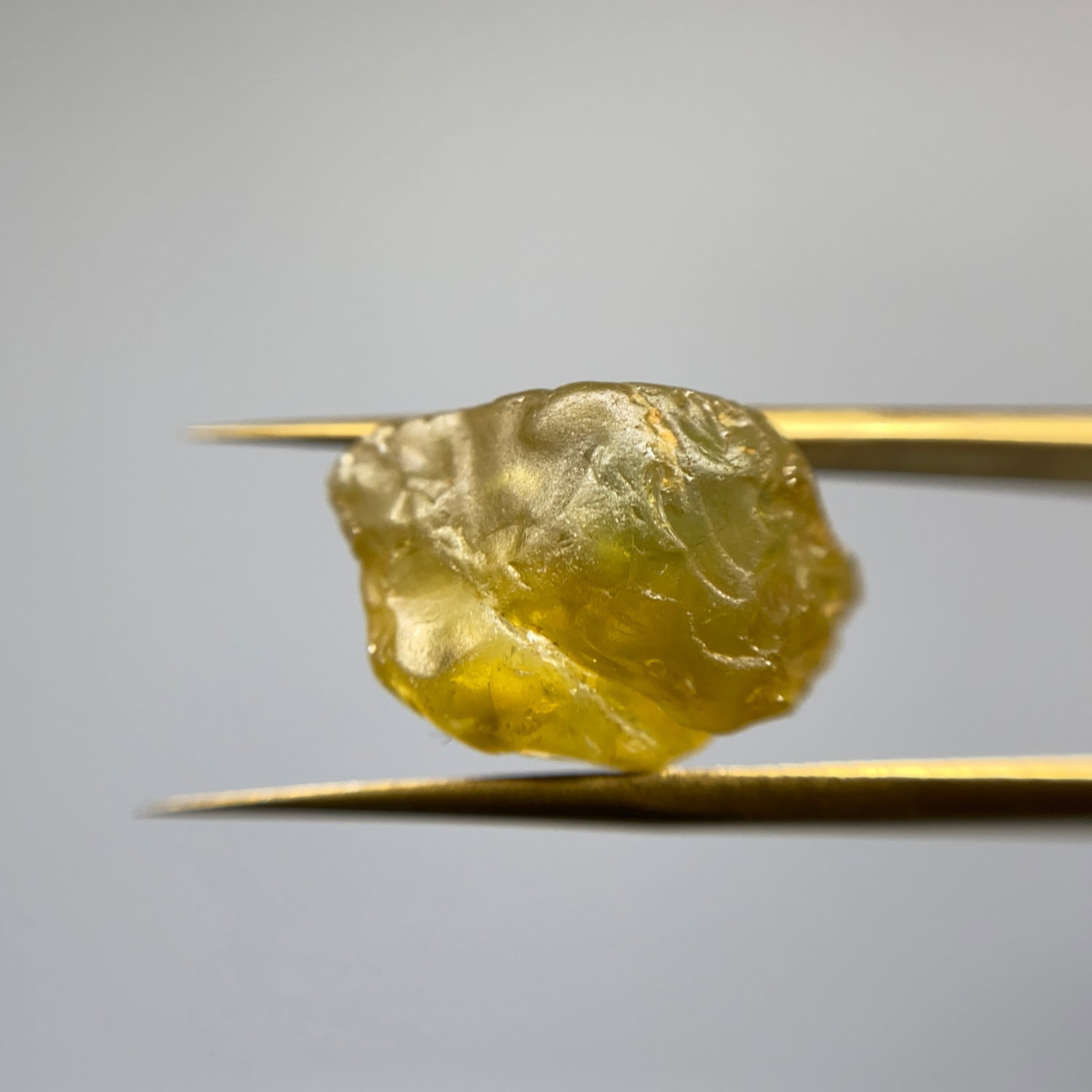 Rare Rough Natural Sapphire Specimen: A heavy 13.61ct natural rough sapphire corundum specimen showing characteristic crystal habit and earth-mined color zoning. Heavy, earth-mined sapphire corundum showing intact crystal habit is rarely 