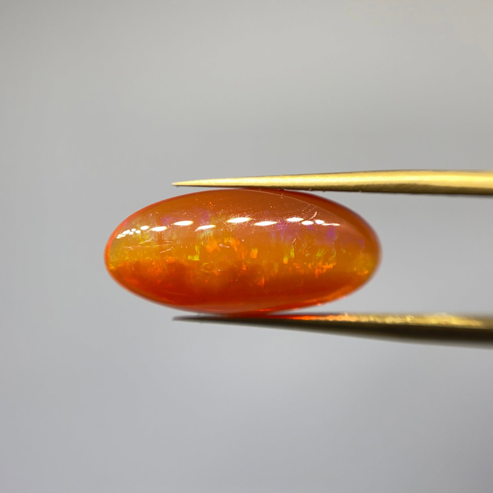 Rare Natural Fire Opal Gemstone: A brightly saturated 3.14ct fire opal cut to maximize brilliance, displaying a vivid and fiery primary hue. The vibrant, fiery primary hue of this gem is a rare occurrence in modern yields. Personally