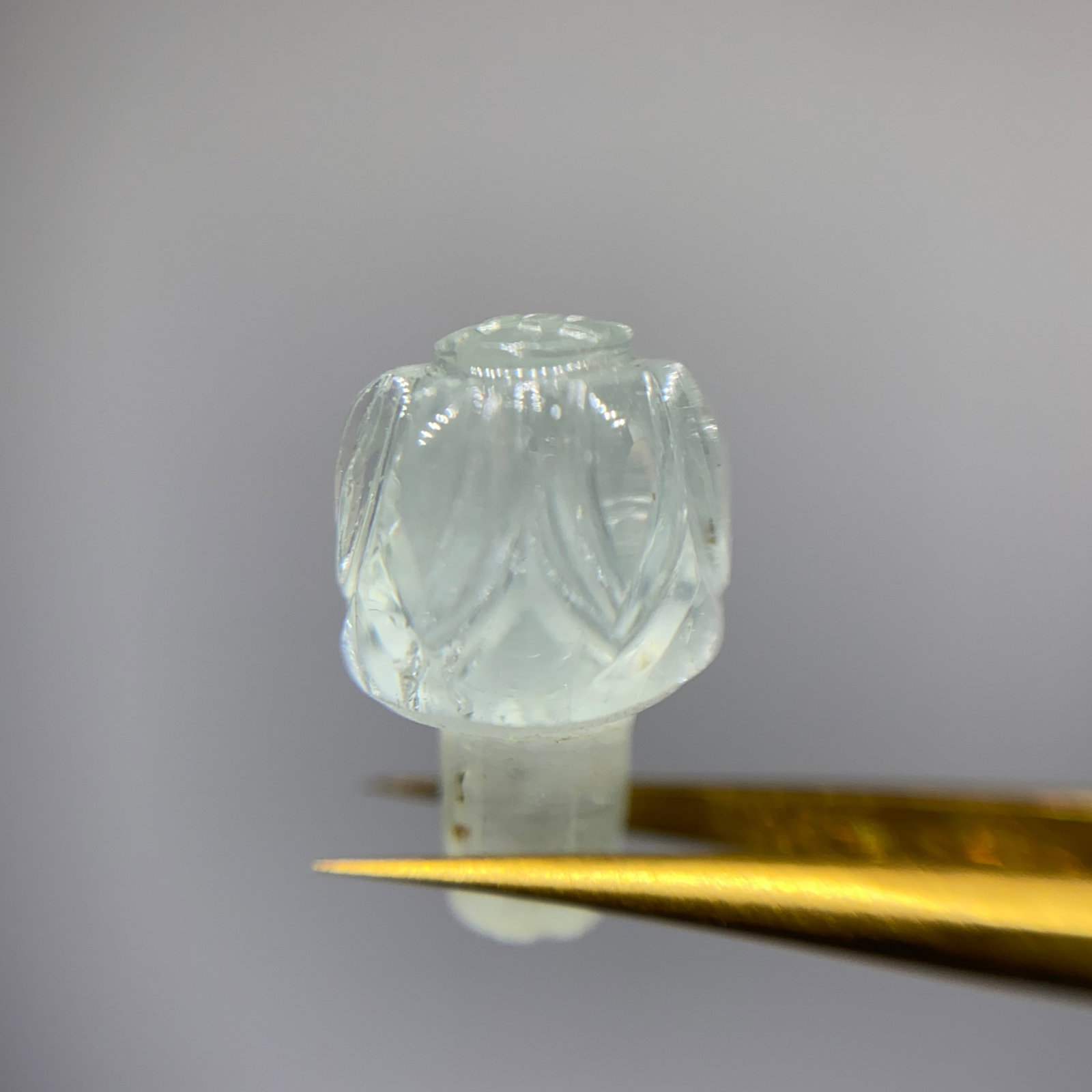 Rare Hand-Carved Aquamarine Crystal Sculpture: A meticulously carved 7.71ct natural aquamarine displaying fine craftsmanship and the stone's natural vitreous luster. Hand-carved aquamarine preserving such fine vitreous luster is a rare artisan fea