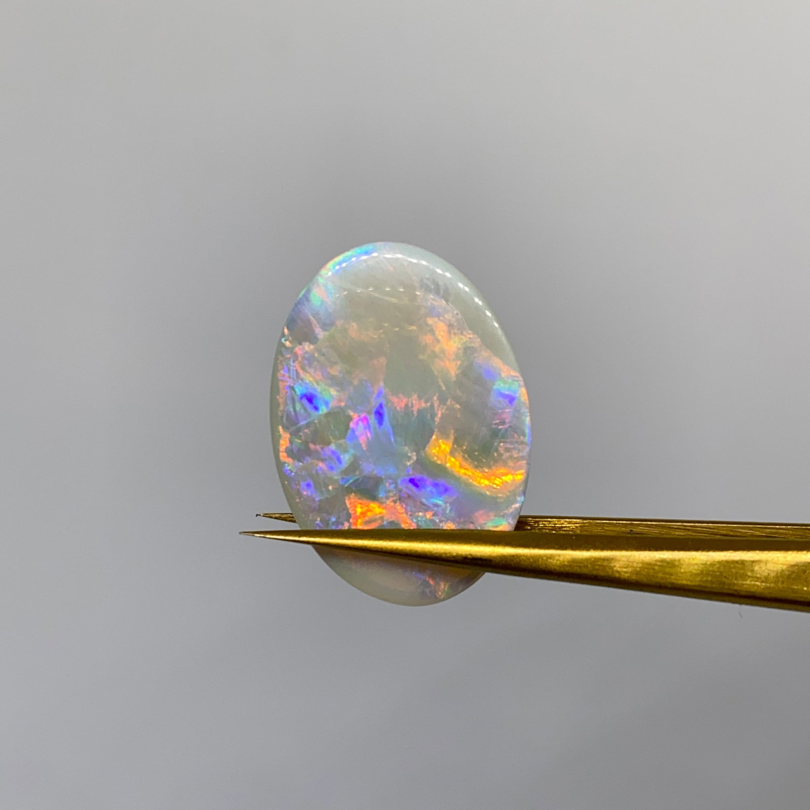 Rare Natural Oval Opal Cabochon: A large 8.00ct, nicely domed opal cabochon displaying a dynamic play-of-color and beautiful natural patterning. An 8-carat solid opal with this dynamic play-of-color is a rare outback discovery. Perso