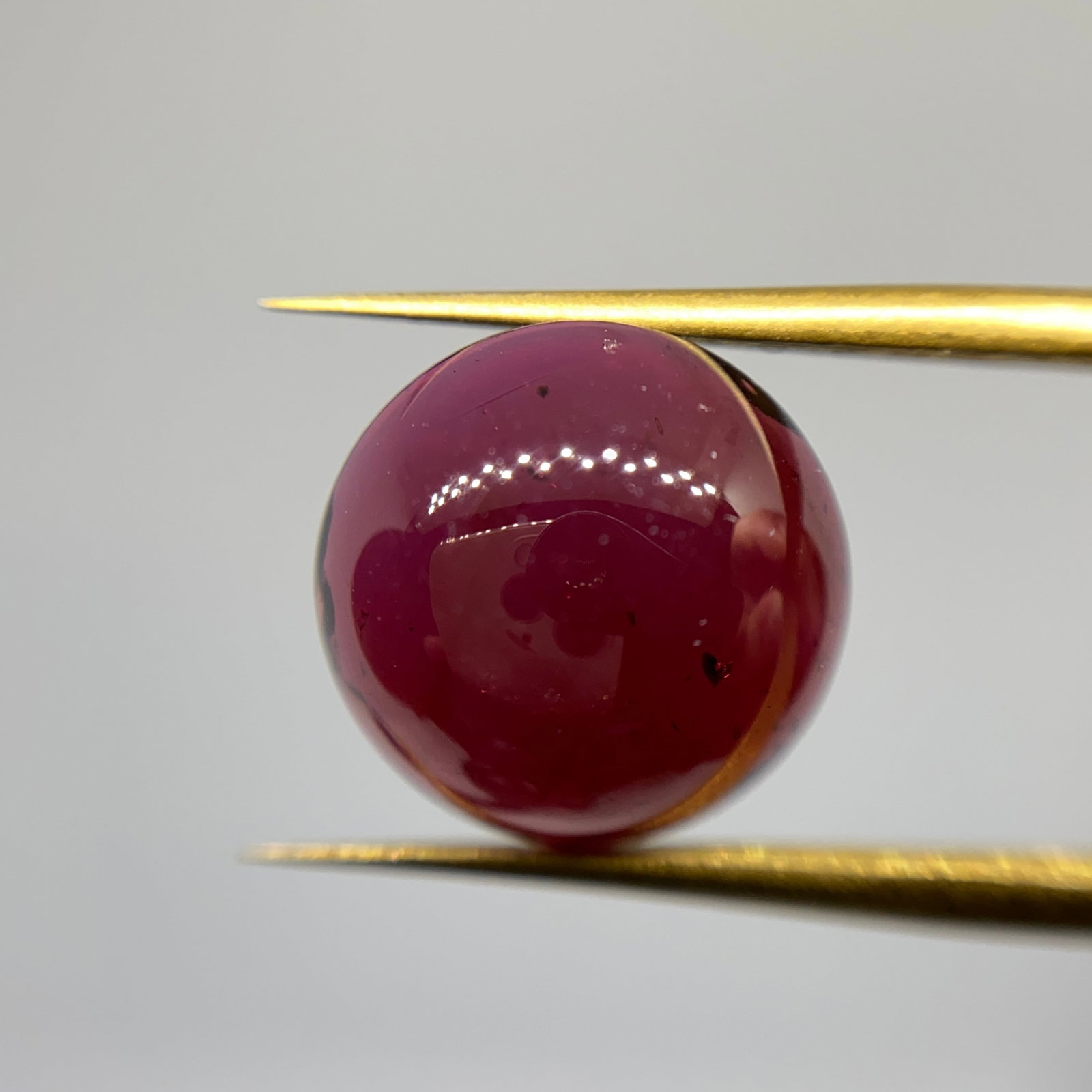 Rare Natural Garnet Cabochon Gemstone: A deeply saturated 5.55ct garnet cut into a smooth, high-domed cabochon, possessing rich crimson hues. High-domed garnets exceeding 5 carats with this crimson purity are highly unusual. Personally rev