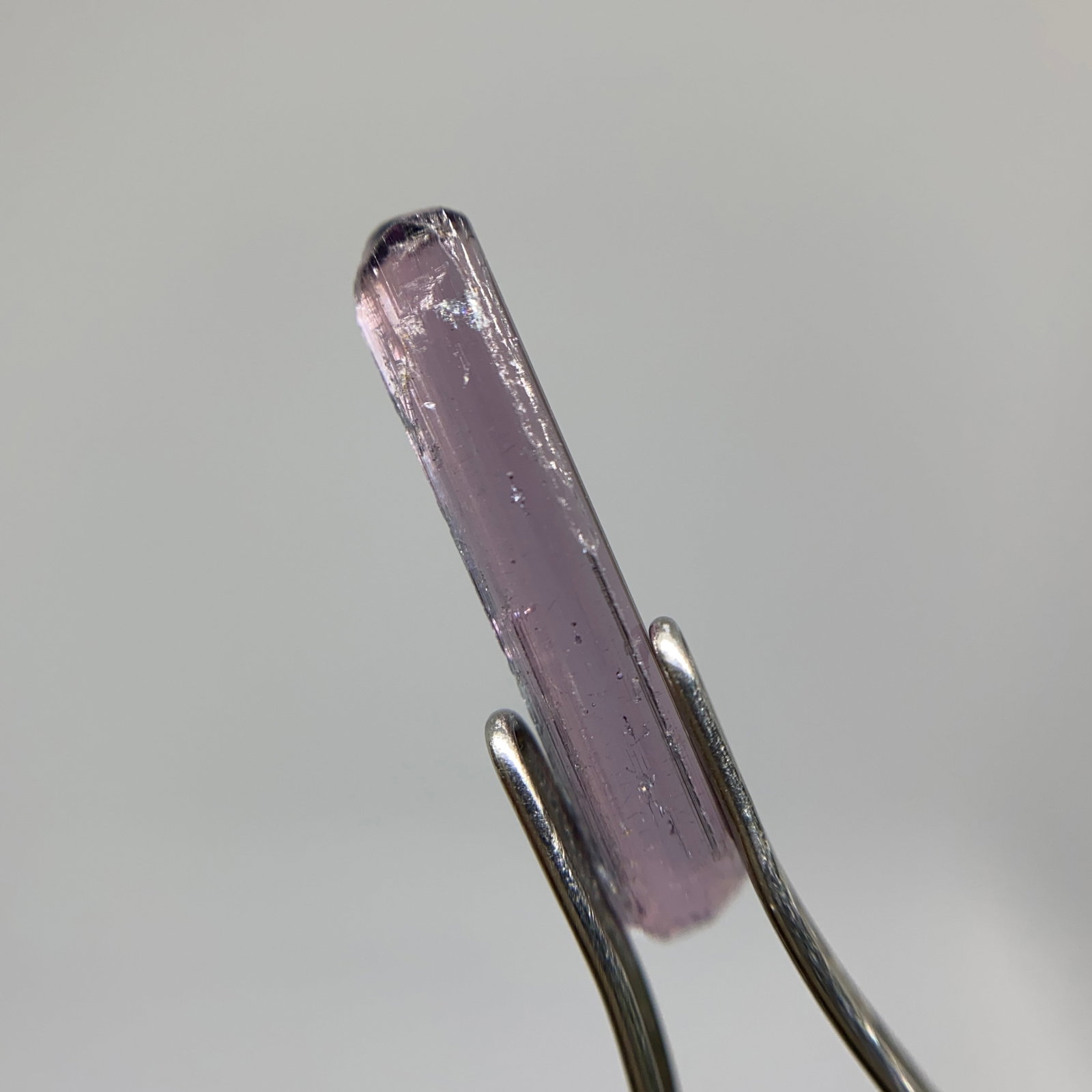 Rare Rough Tourmaline Mineral Specimen: A raw, natural 1.06ct tourmaline crystal fragment showcasing distinct pleochroism and natural structural faces. Raw fragments showing such distinct pleochroism are rare study pieces. Personally review