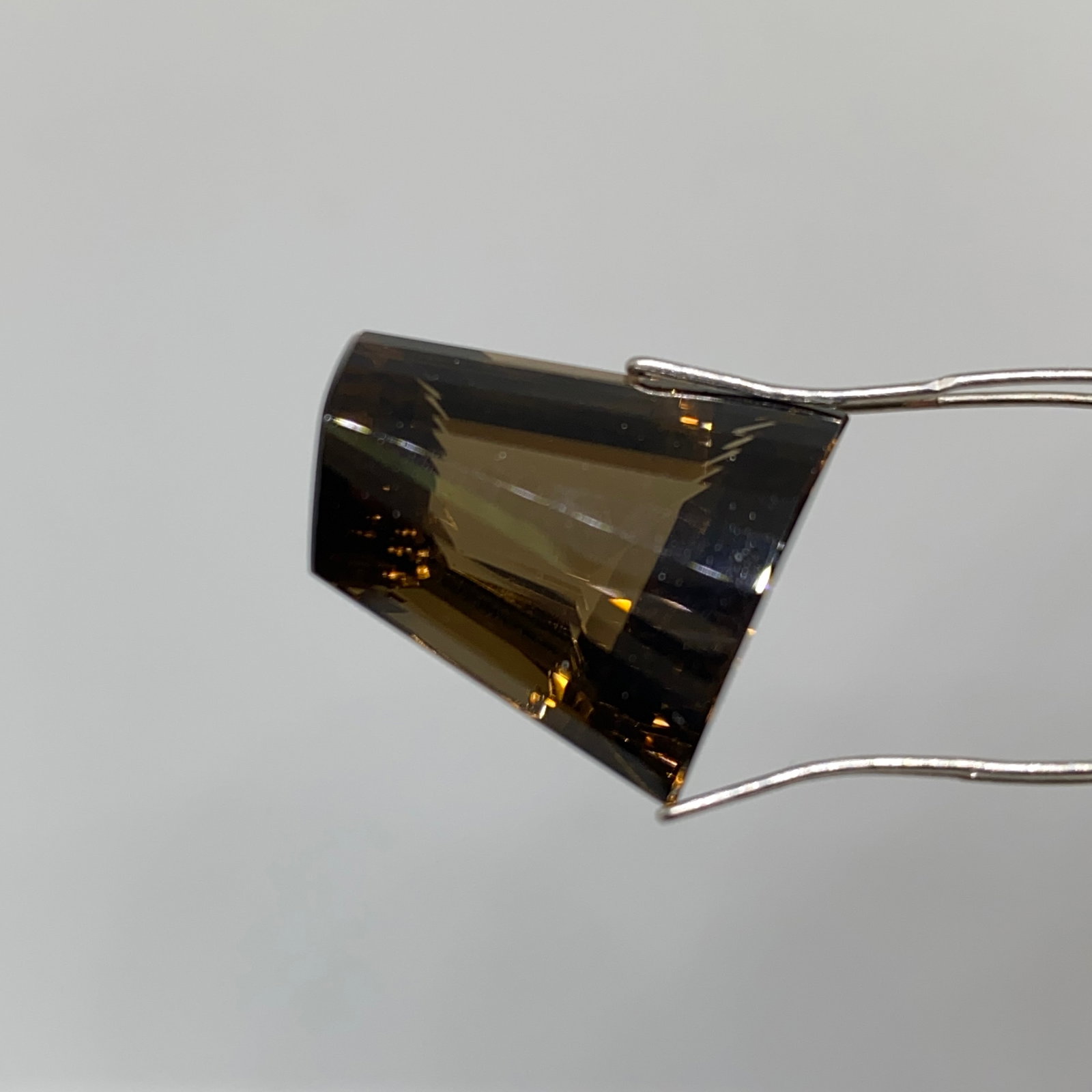 Rare Natural Smoky Quartz Gemstone by Francis J. Sperisen: A beautifully faceted 19.76ct smoky quartz displaying an even, rich brown body color and superb clarity. Rich brown smoky quartz with this flawless internal clarity is a rarity in modern markets. This