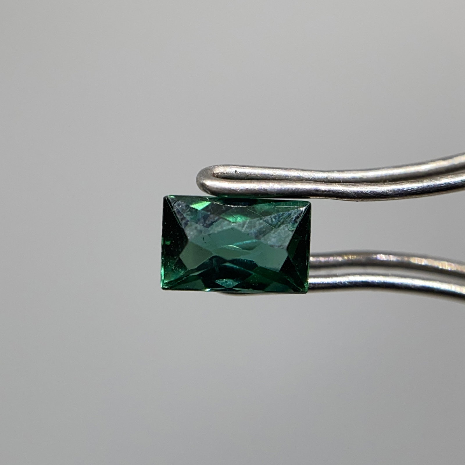 Rare Natural Blue Tourmaline Gemstone: A lively 0.34ct indicolite tourmaline with superior saturation, perfect as a fine accent stone. High-quality indicolite with this superior saturation is a rare find even in small carat weights. Person