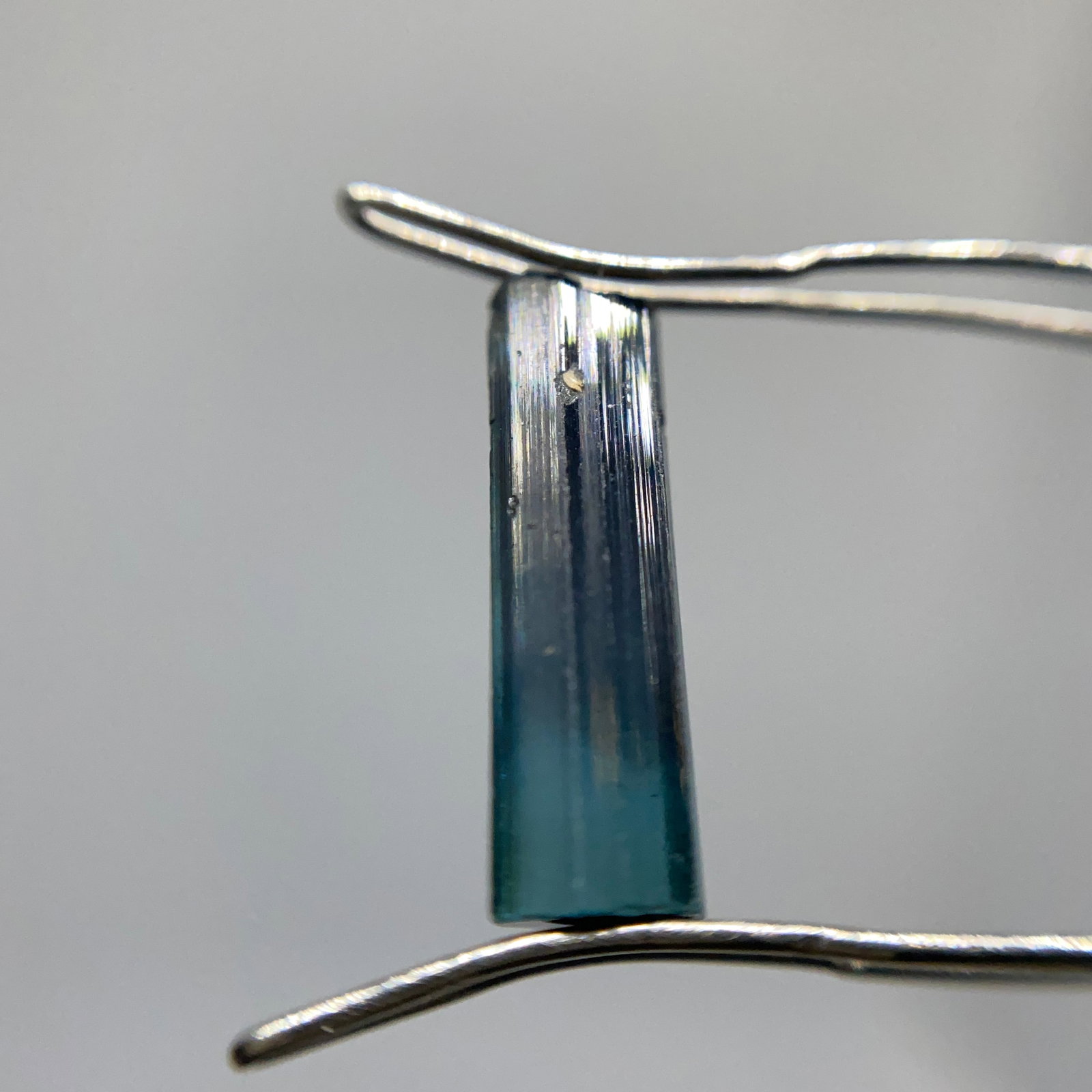 Rare Rough Tourmaline Mineral Specimen: A raw 2.46ct tourmaline crystal showing distinct natural facets and vibrant earth-mined coloration. Vibrant earth-mined coloration in a distinctly faceted raw crystal is very rare. Personally reviewed