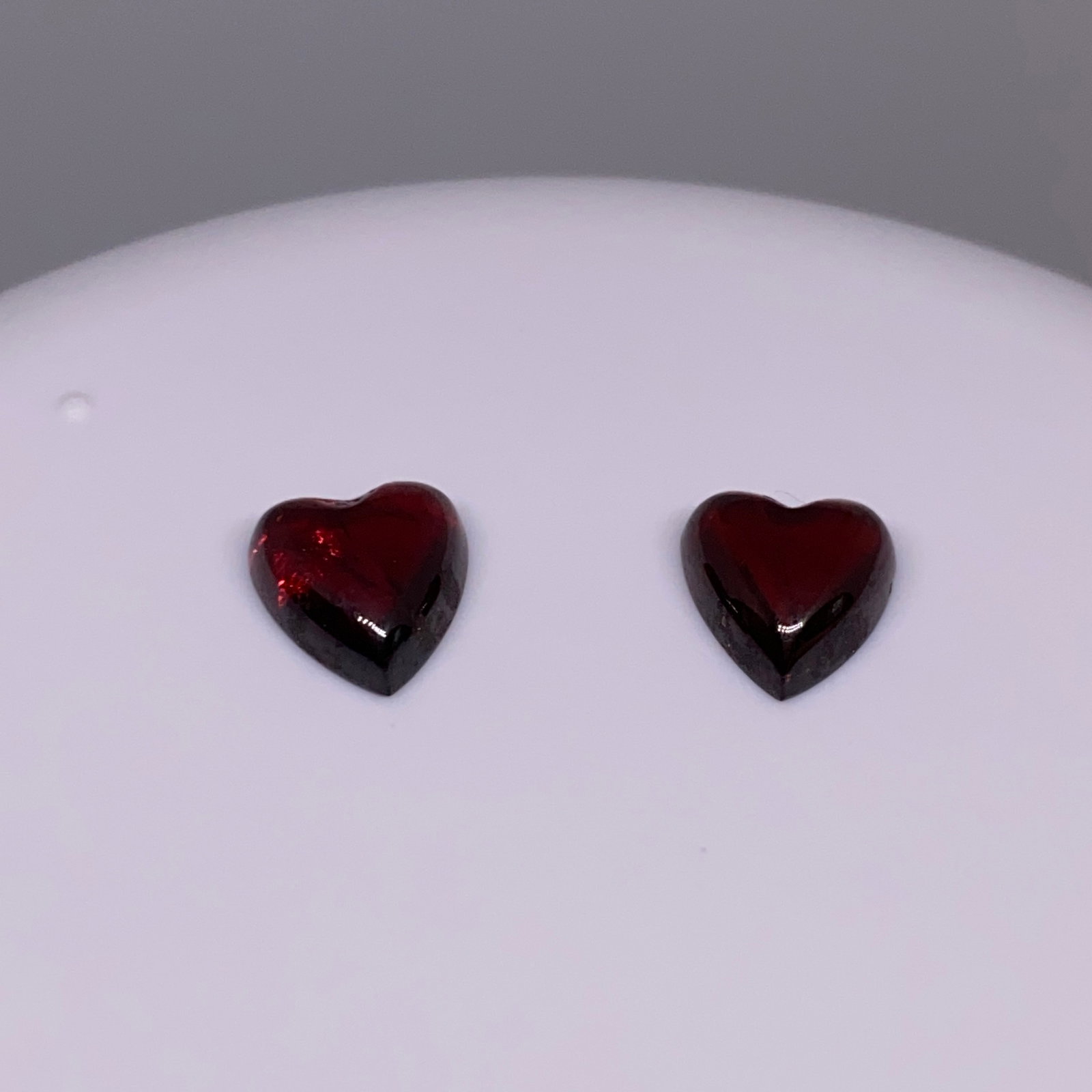 Rare Natural Heart Garnet Gemstone Pair: A beautifully matched 5.00ct pair of heart-cut natural garnets exhibiting deep, romantic crimson hues and high brilliance. Matched 5-carat heart-cut garnets with deep crimson hues are exceptionally ra