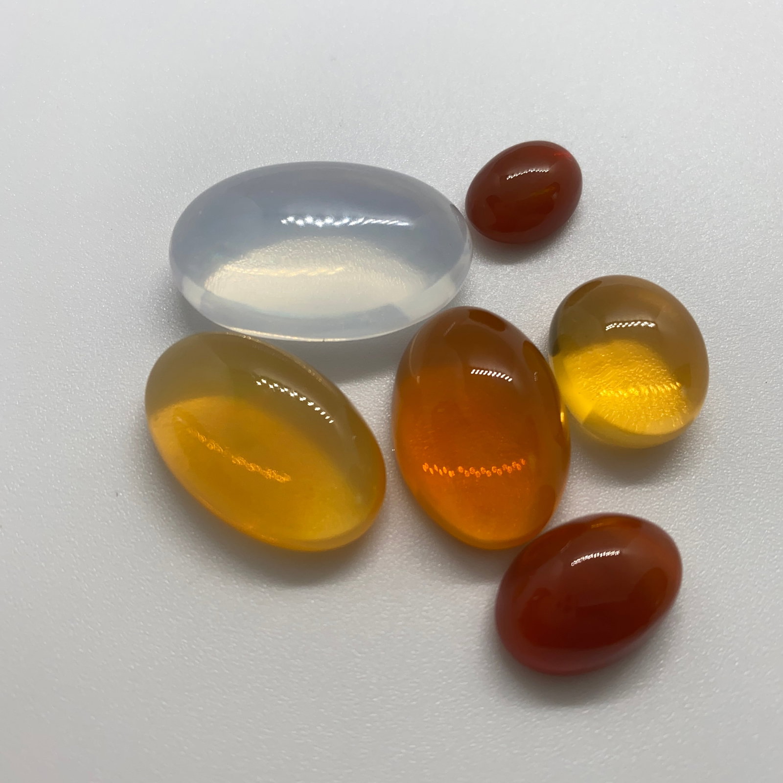 Rare Natural Opal Gemstone Lot: A high-volume 83.83ct parcel of natural opals displaying excellent aggregate play-of-color, perfect for volume designers. 83 carats of natural opals with this excellent aggregate play-of-color is a ra