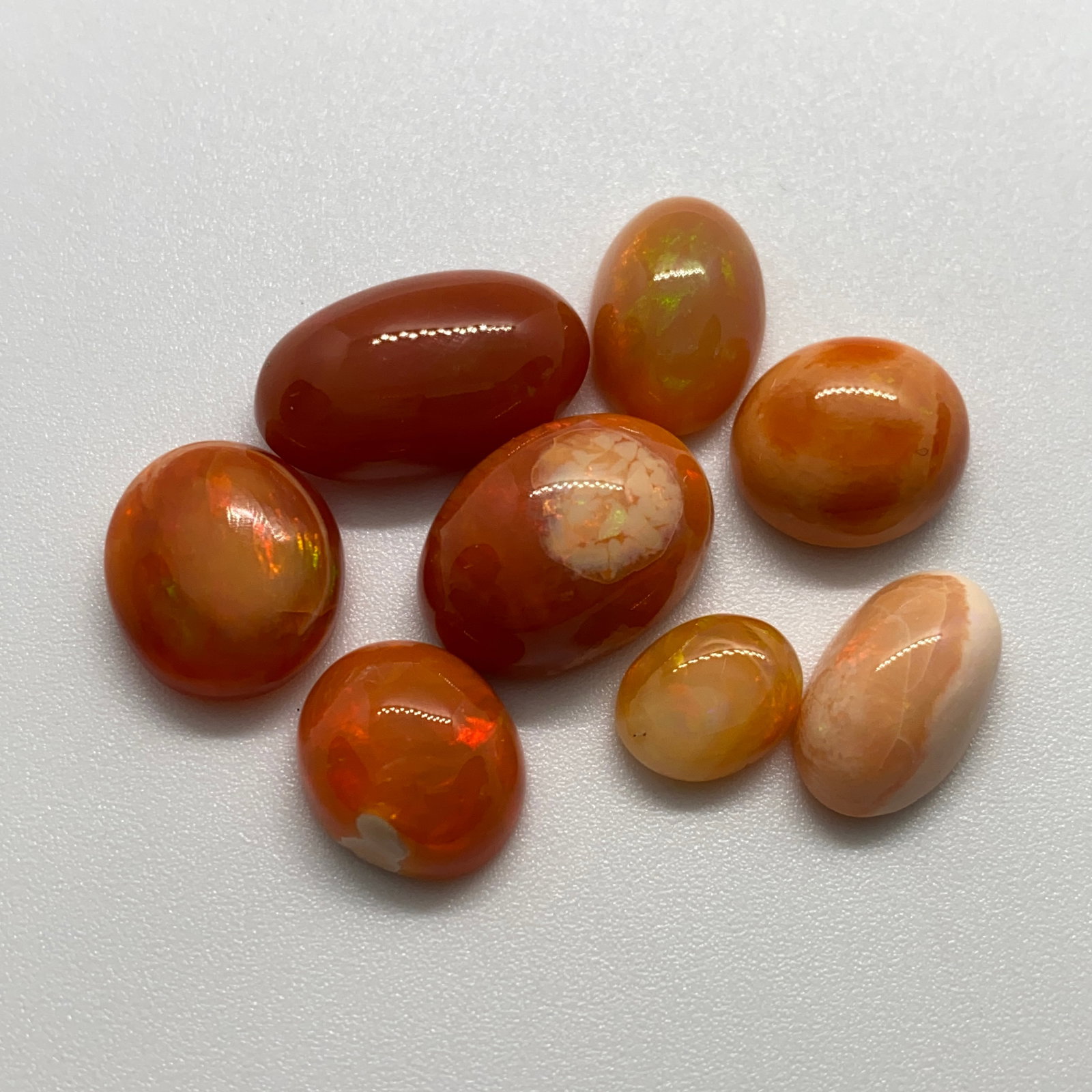 Rare Natural Opal Gemstone Mixed Lot: A substantial 50.91ct parcel of opals offering an incredible variety of patterns, flashes, and natural tones. Substantial 50-carat collector parcels offering this variety of patterns are rare market o