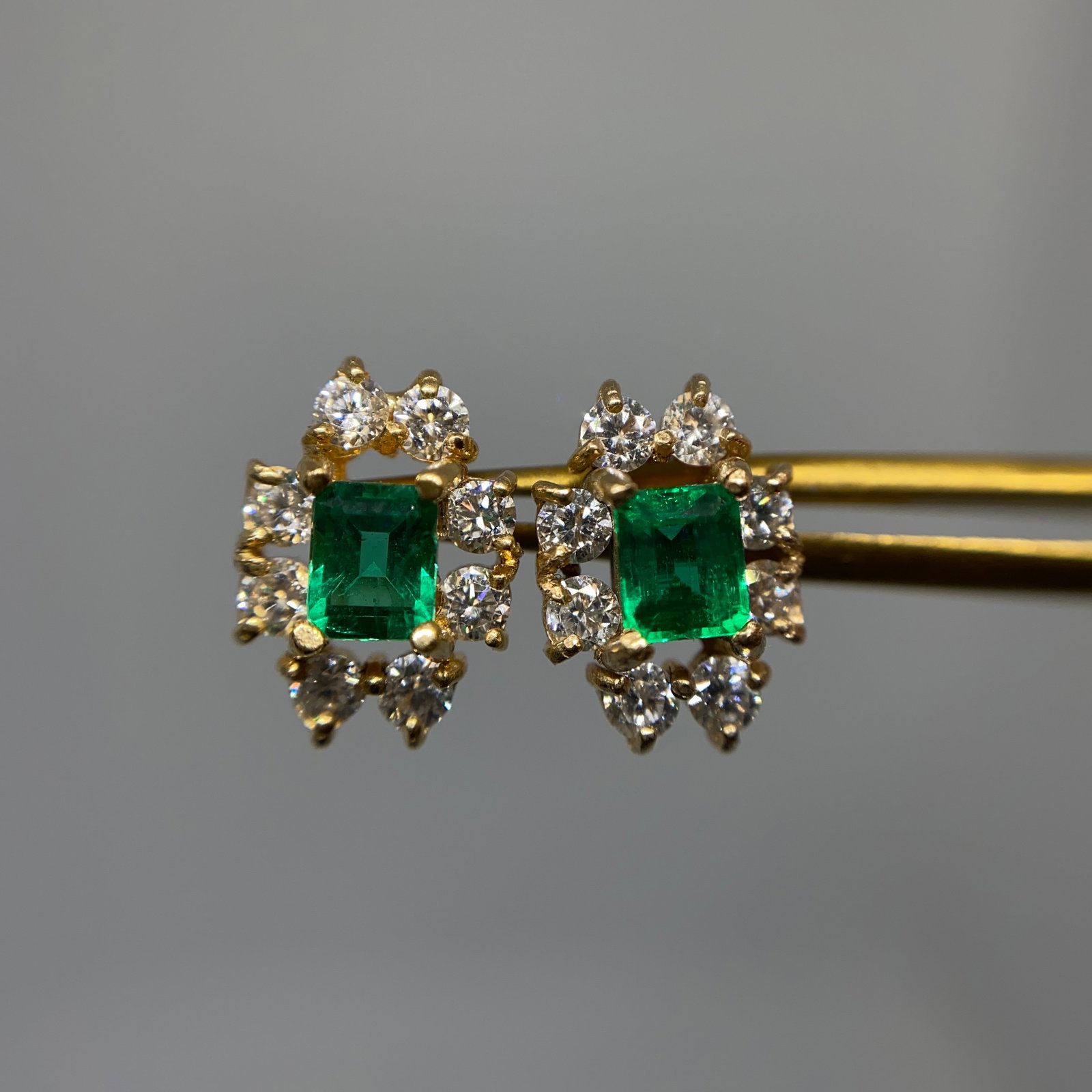 Heirloom 18K Yellow Gold Muzo Emerald Earrings: Elegant 2.14g 18K gold estate earrings featuring exceptionally rare, intensely saturated green Colombian Muzo emeralds. Intensely saturated Colombian Muzo emeralds represent the absolute pinnacle of r