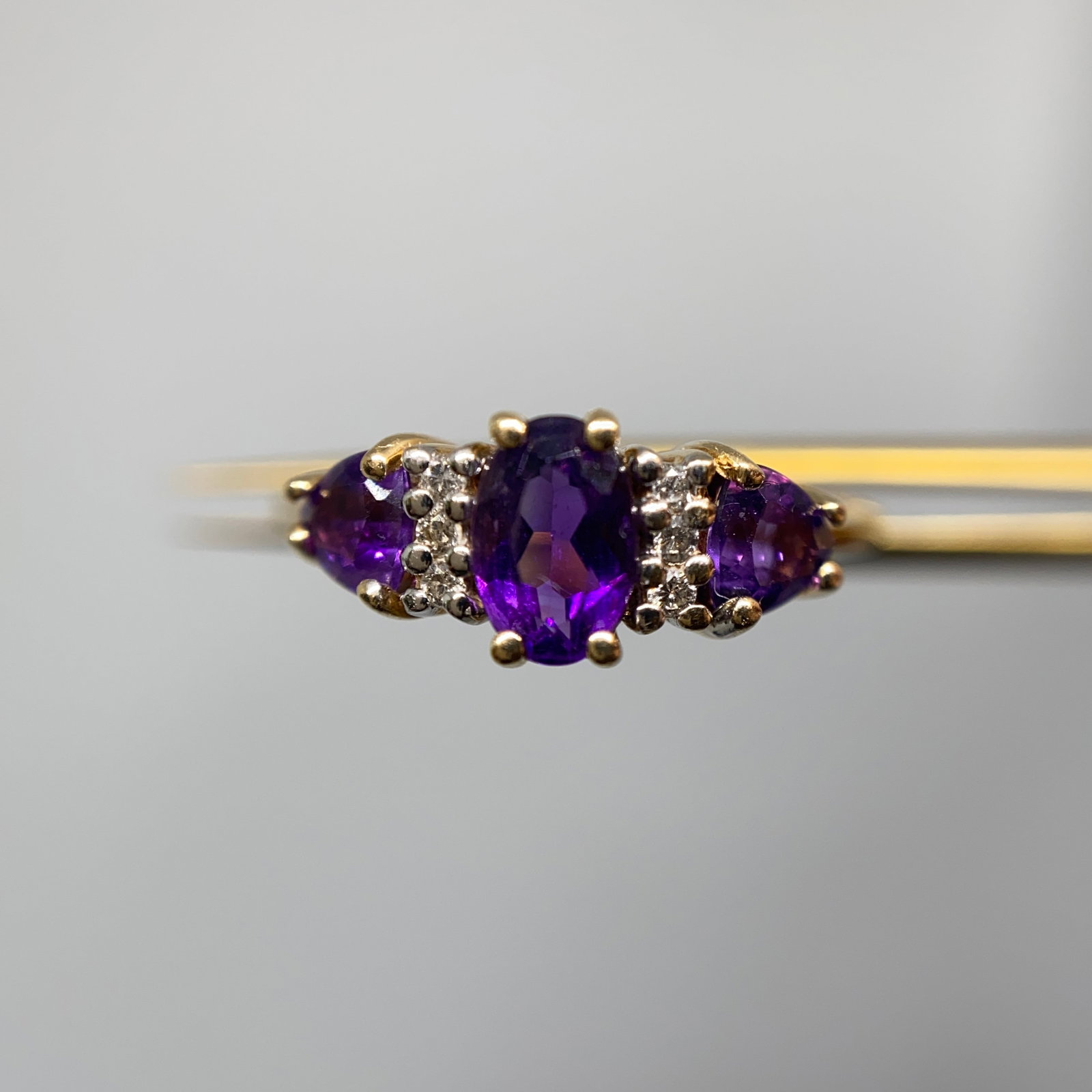 Heirloom 14K Gold Diamond & Amethyst Ring Size 14: A large-sized 1.94g 14K gold estate ring boasting a deeply saturated amethyst center stone flanked by bright diamond accents. Large-sized estate rings boasting this deeply saturated amethyst quality a