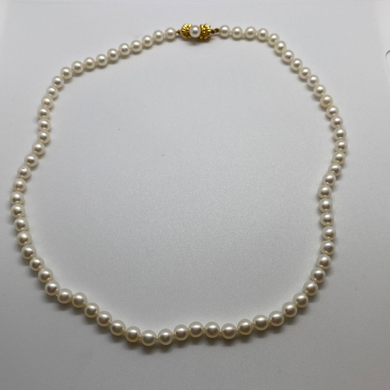 Heirloom 18K Gold Signed Mikimoto Akoya Pearl Necklace 18-Inch: A fully hallmarked 20.13g genuine Mikimoto 18-inch necklace featuring a perfectly matched strand of highly lustrous Akoya pearls. Genuine, fully hallmarked Mikimoto strands with this world-class Akoya