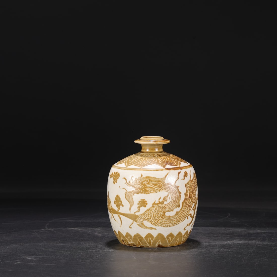 A brown color carved cloud dragon pattern pomegranate vase from the Song Dynasty Ding kiln: The brown color carved cloud dragon pattern pomegranate bottle of the Song Dynasty Ding kiln Size:D:15.5cm Calibre:3cm Belly diameter:11.5cm (The Dimensions Of All Batches Are Manually Measured.If You
