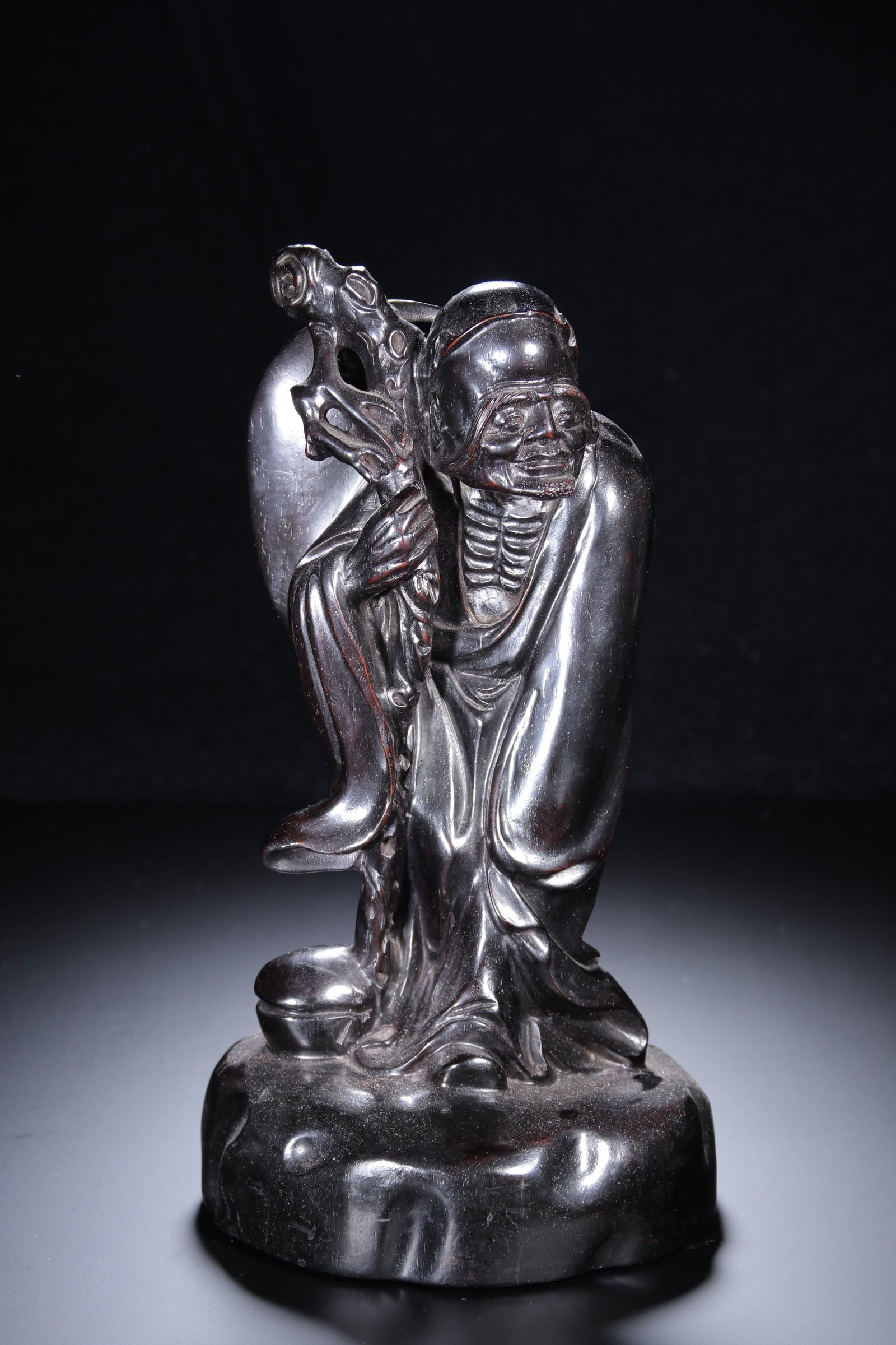 A Qing Dynasty sandalwood carved long-eyebrowed Arhat ornament: Qing Dynasty sandalwood carved long-eyebrowed Arhat ornament Size:H:29cm W:15.5cm W:2.133kg (The Dimensions Of All Batches Are Manually Measured.If You Need More Detailed Information, Please Contact