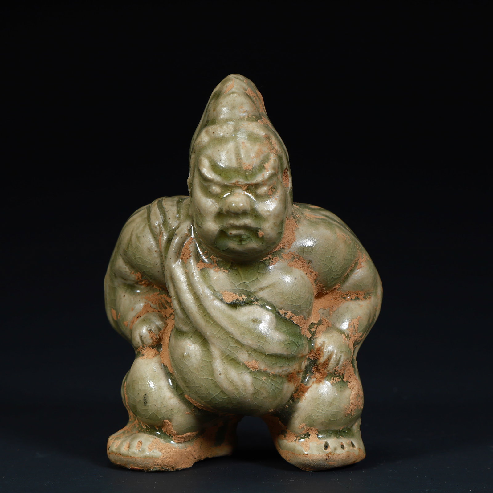 A celadon wrestler figurine from the Yue kiln in the Tang Dynasty: The celadon wrestler figurines of the Yue kiln in the Tang Dynasty Size:H:11.5cmxL:9cmxW:6.5cm W: 0.4kg (The Dimensions Of All Batches Are Manually Measured.If You Need More Detailed Information,