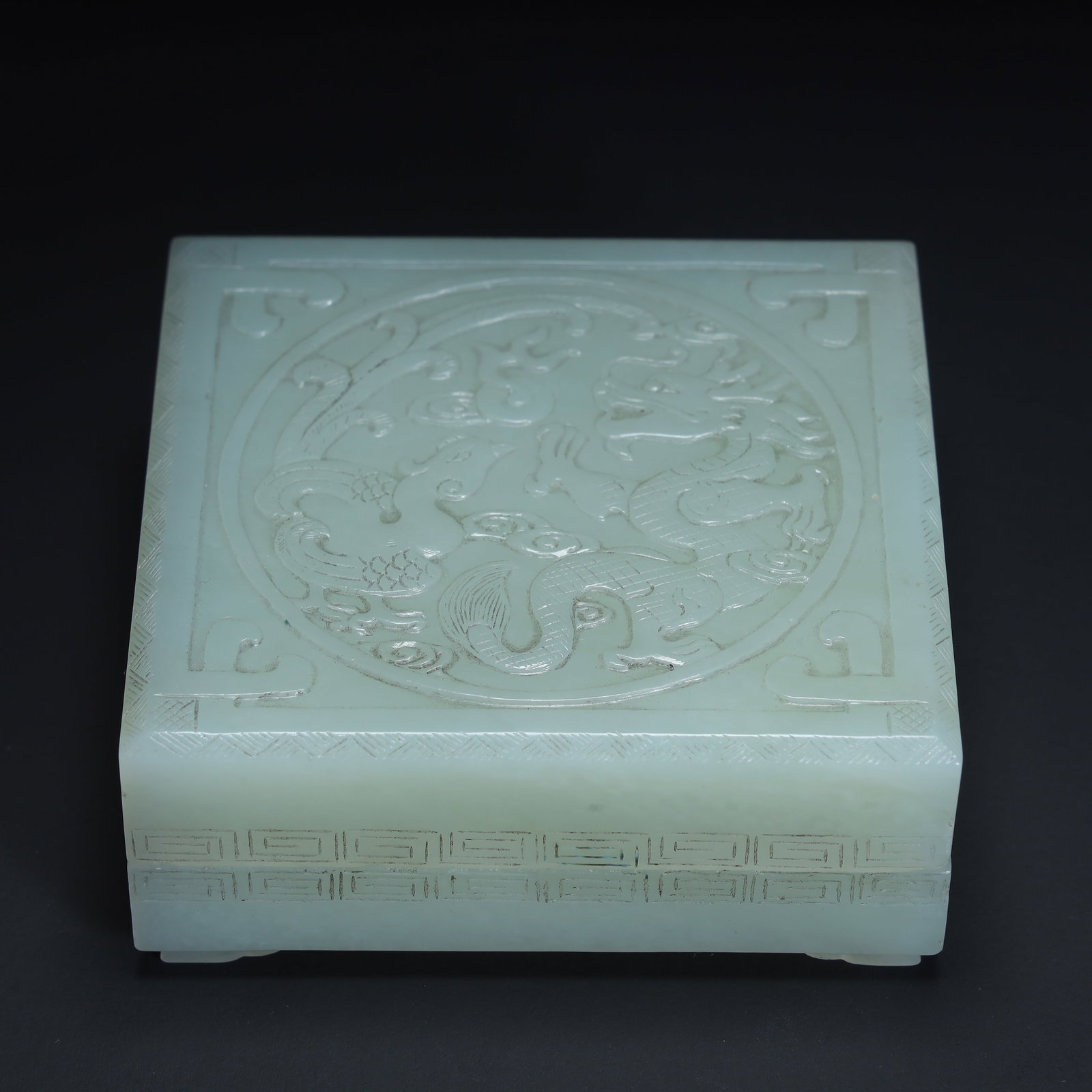 A Qing Dynasty Hetian green and white jade dragon and phoenix auspicious pattern square box: The Qing Dynasty's Hetian green and white jade dragon and phoenix presented an auspicious pattern square box Size:H:3.5cmxL:8cmxW:8cm W: 0.31kg (The Dimensions Of All Batches Are Manually Measured.If 