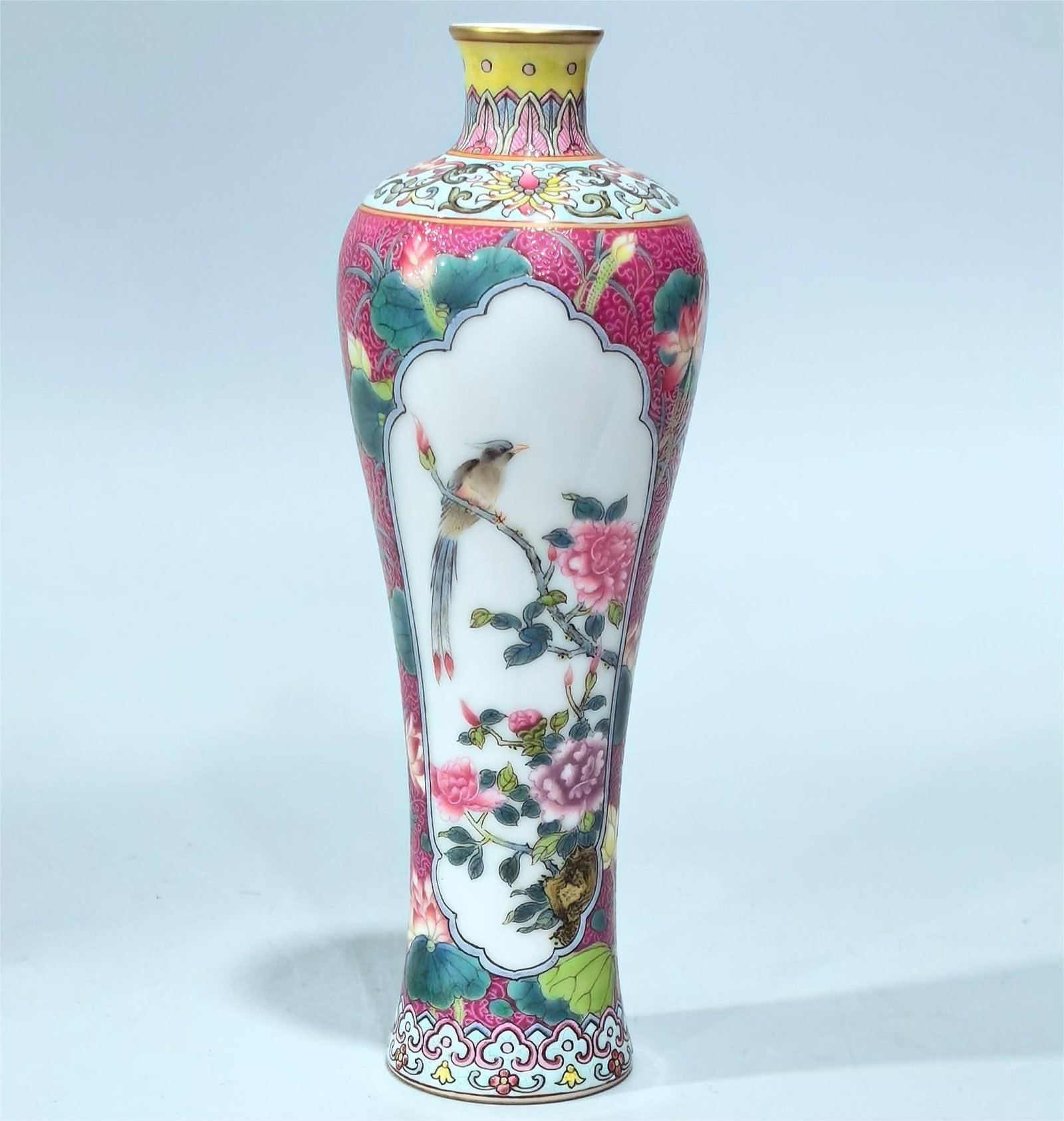 A small plum bottle with a Qing Dynasty enamel carmine red track flower window flower and bird: Qing Dynasty enamel carmine red track flower opening window flower bird pattern small plum bottle Size:H:14.5cm Belly diameter:5cm (The Dimensions Of All Batches Are Manually Measured.If You Need More