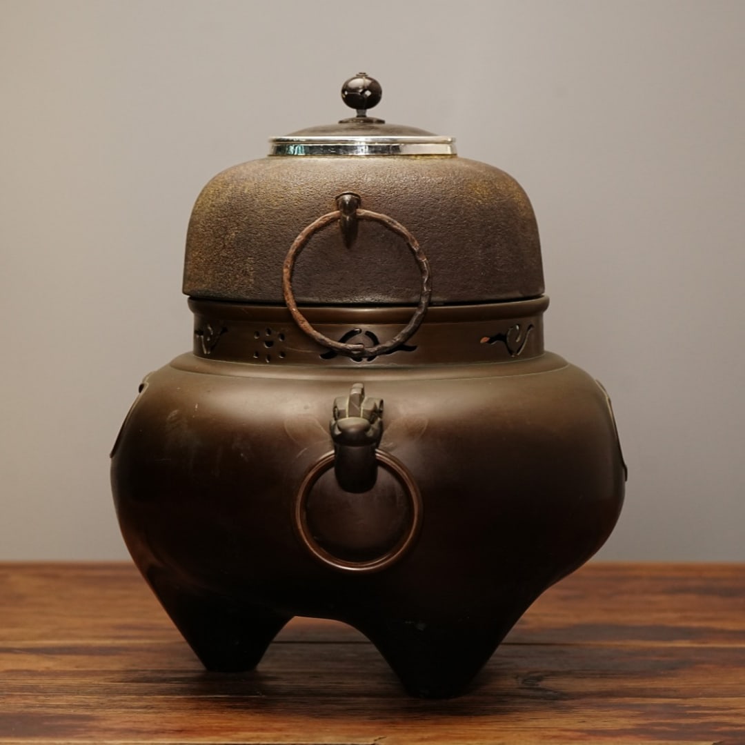 A delicate silver kettle with rings and an iron-wrapped silver cauldron and wind stove (1 of 8)