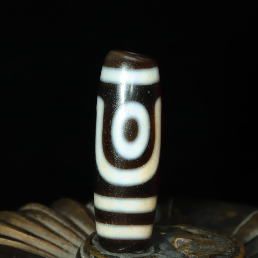 A delicate two-eyed cinnabar dzi bead (1 of 9)