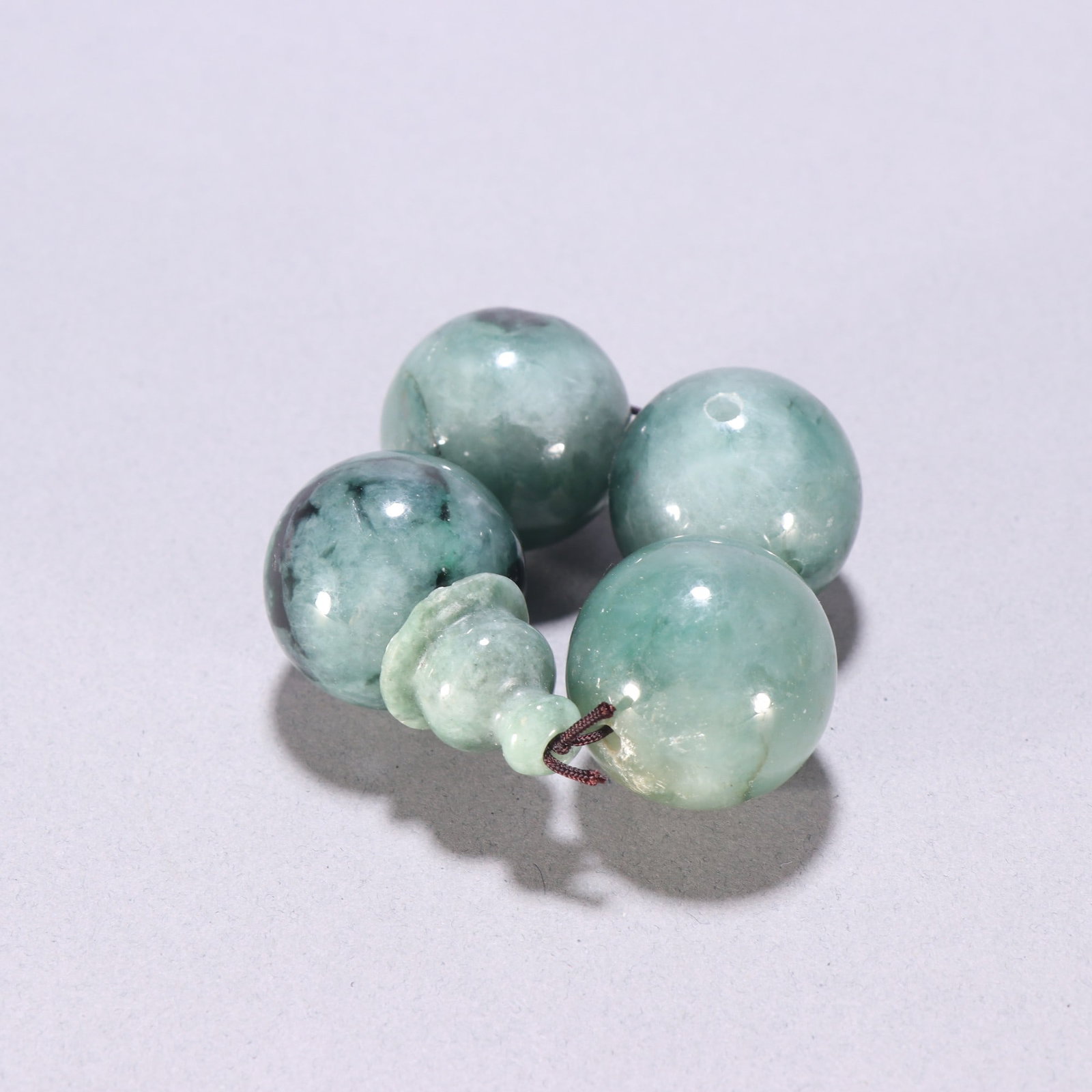 A Qing Dynasty jadeite three-way bead (1 of 9)