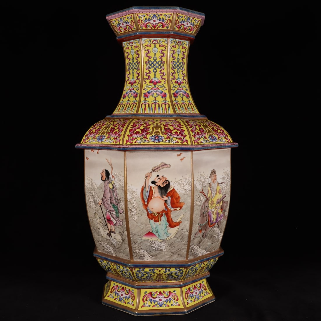 A Qing Dynasty Qianlong period yellow ground famille rose Eight Immortals figure-inlaid eight-sided: A yellow-ground famille rose Eight Immortals figure-inlaid eight-sided artifact made during the Qianlong period of the Qing Dynasty Size: H: 50cm Calibre 16.6cm Belly diameter: 27cm foot: 20cm Size: H