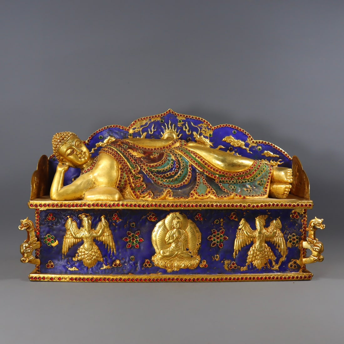 A Qing Dynasty red-copper, gilded, gem-inlaid blue reclining Buddha (1 of 9)