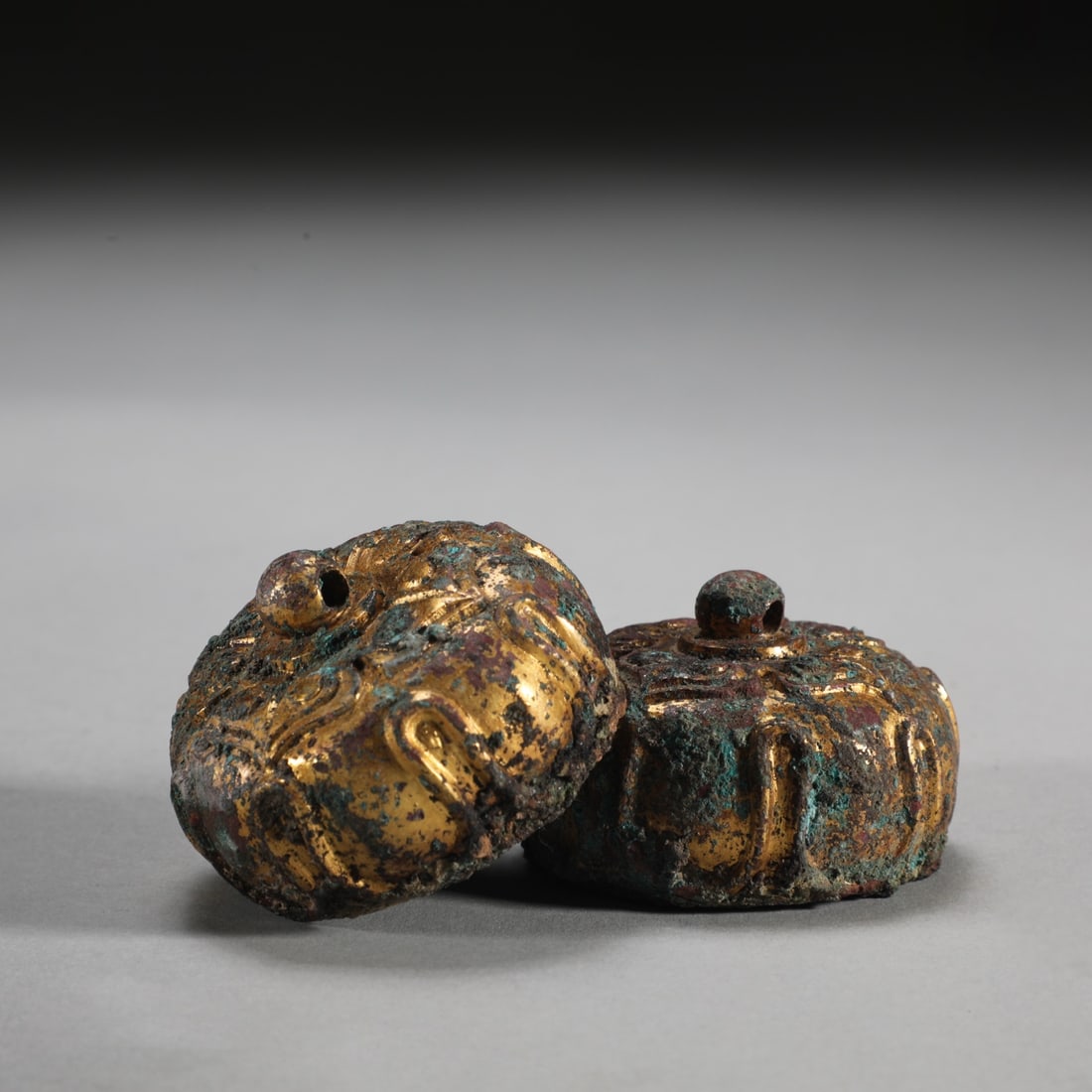 A pair of bronze-bodied, gilded lotus-petal mat weights from the Warring States period (1 of 7)