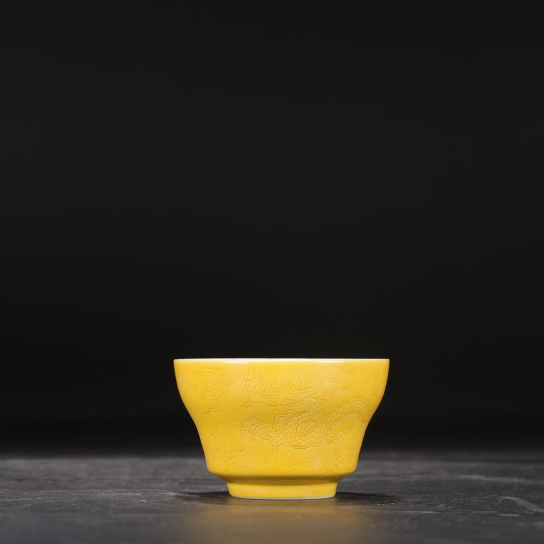 A tea cup from the Ming Dynasty Chenghua with delicate yellow glaze and inlaid cloud and dragon (1 of 7)