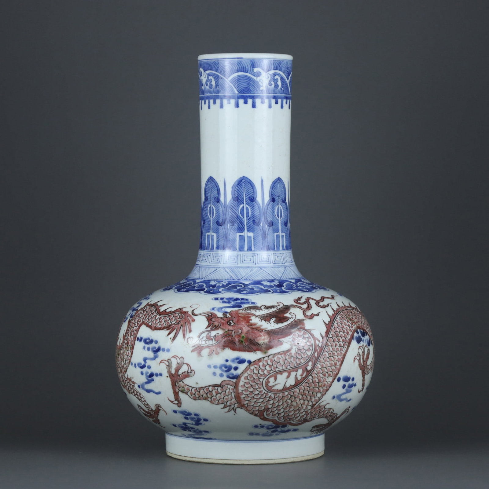 A Qing Dynasty Kangxi period blue-and-white underglaze red dragon pattern celestial globe vase: A blue-and-white glazed red dragon patterned celestial sphere vase made during the Kangxi period of the Qing Dynasty Size: H: 33.3cm Belly diameter: 21.5cm Size: H: 33.3cm Belly diameter: 21.5cm (The 