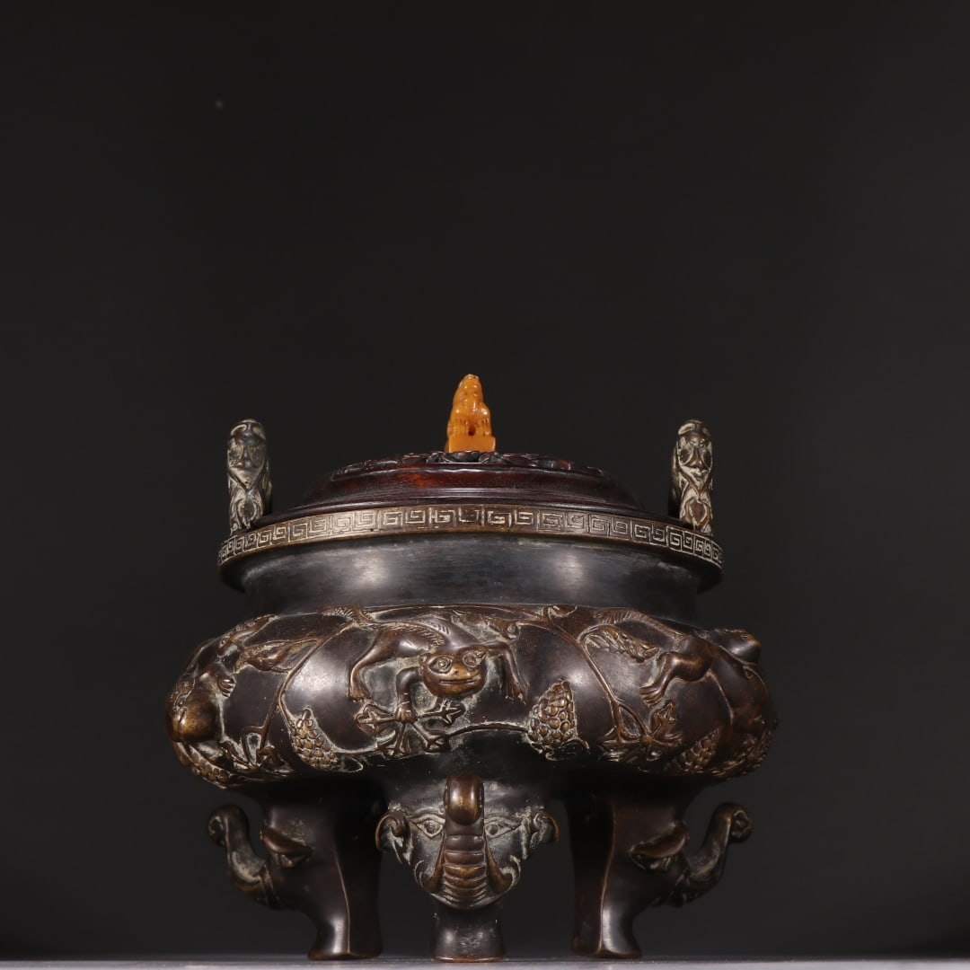 A copper pine and grape three-legged incense burner made during the Xuande period of the Ming: A bronze pine grape three-legged incense burner made during the Xuande period of the Ming Dynasty Size: H: 15.2cm W: 16.2cm W: 2.9302 kg Size: H: 15.2cm W: 16.2cm W: 2.9302 kg (The Dimensions Of All B