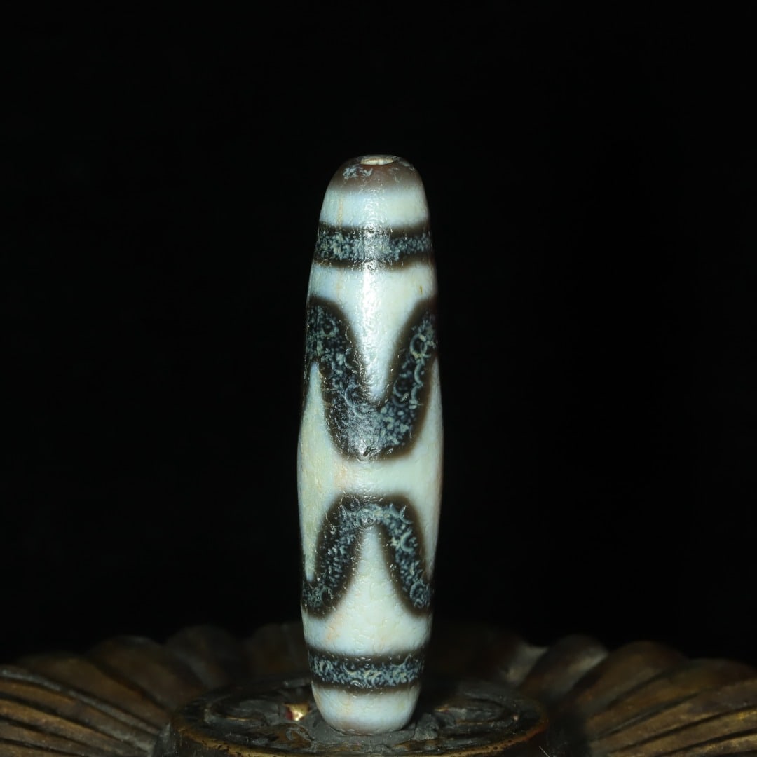 A beautiful tiger-tooth cinnabar Dzi bead (1 of 9)