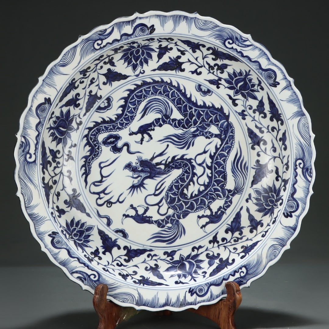 A Yuan dynasty blue-and-white plate with entwined lotus branches, clouds, and dragon patterns on the (1 of 9)
