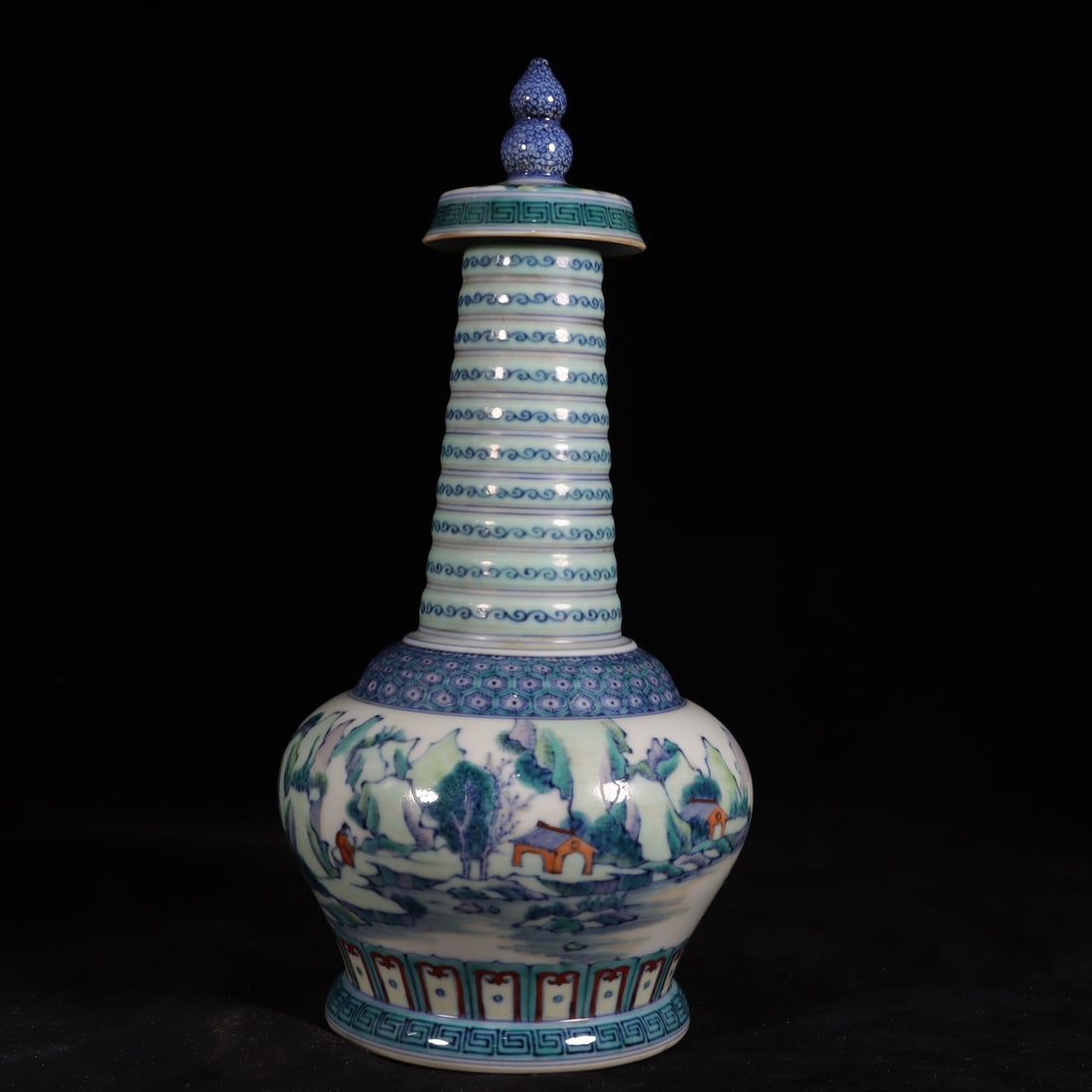 A Qing Dynasty Kangxi period blue-and-white doucai landscape figure pagoda vase: A blue-and-white doucai landscape and figure pagoda vase made during the Kangxi period of the Qing Dynasty Size: H: 26.8cm Calibre 3.5cm bottomD: 9.9cm Size: H: 26.8cm Calibre 3.5cm bottomD: 9.9cm (Th
