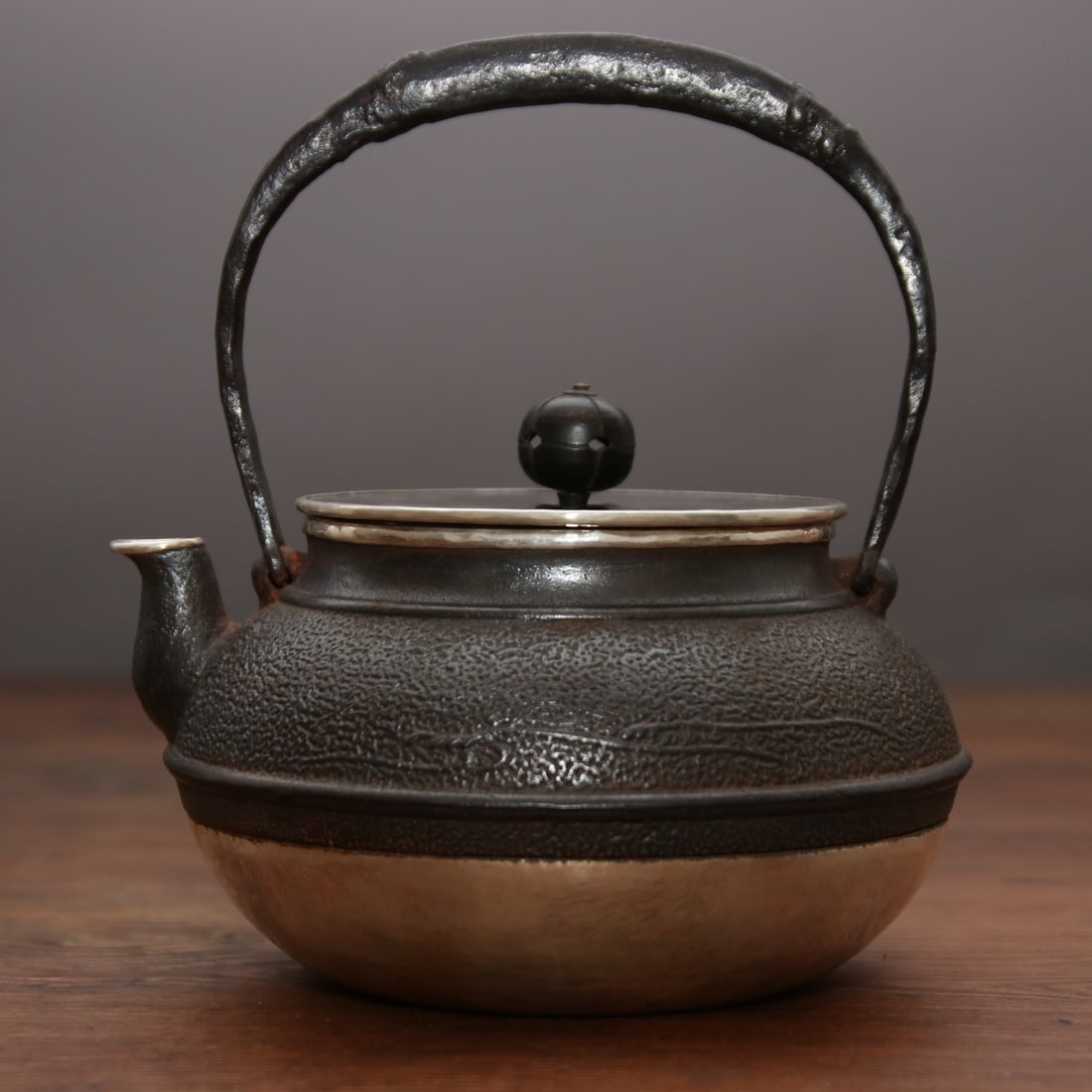 A finely crafted iron-wrapped silver kettle from the East Chamber (1 of 8)