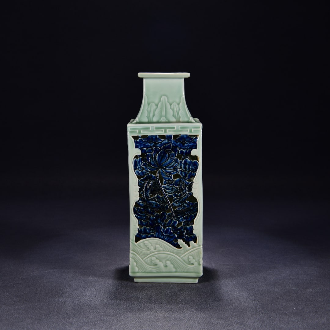 A bean blue glaze transparent carved blue and white flower pattern square bottle made in the: A square vase with openwork blue-and-white floral patterns made during the Qianlong period of the Qing Dynasty Size: H: 39cm W: 14cm (The Dimensions Of All Batches Are Manually Measured.If You Need Mo