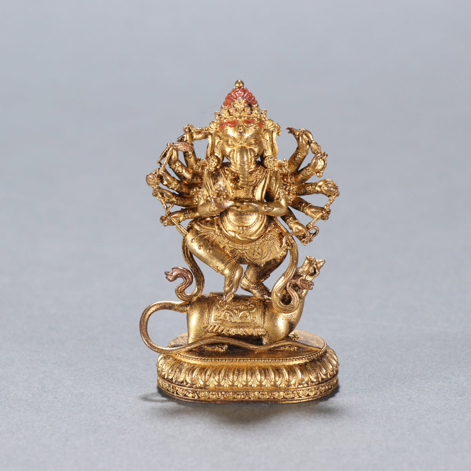 A Qing Dynasty gilt bronze multi-armed elephant head statue of the God of Wealth: A Qing Dynasty gilt bronze statue of the God of Wealth with the head of a multi-armed elephant Size: H: 5.8cm W: 3.8cm W: 0.0535kg (The Dimensions Of All Batches Are Manually Measured.If You Need More