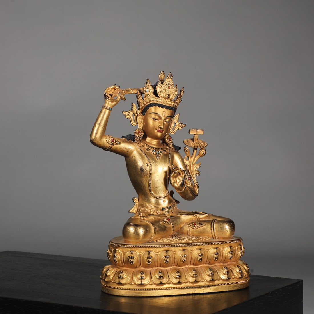 A finely cast gilded seated statue of Manjushri Bodhisattva from the Ming Dynasty with a bronze body (1 of 8)
