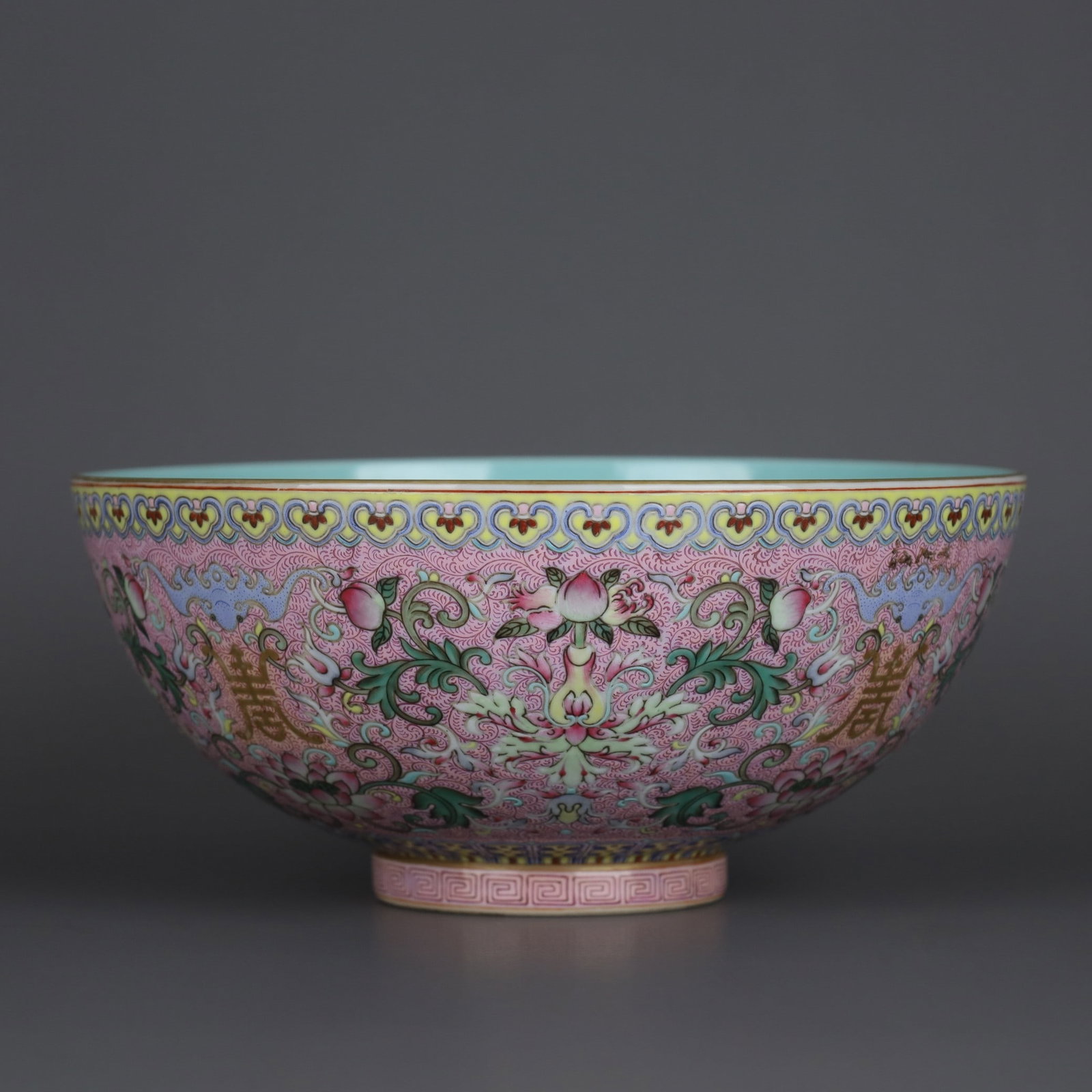 A bowl made during the Qianlong period of the Qing Dynasty, featuring a pink ground with famille (1 of 9)