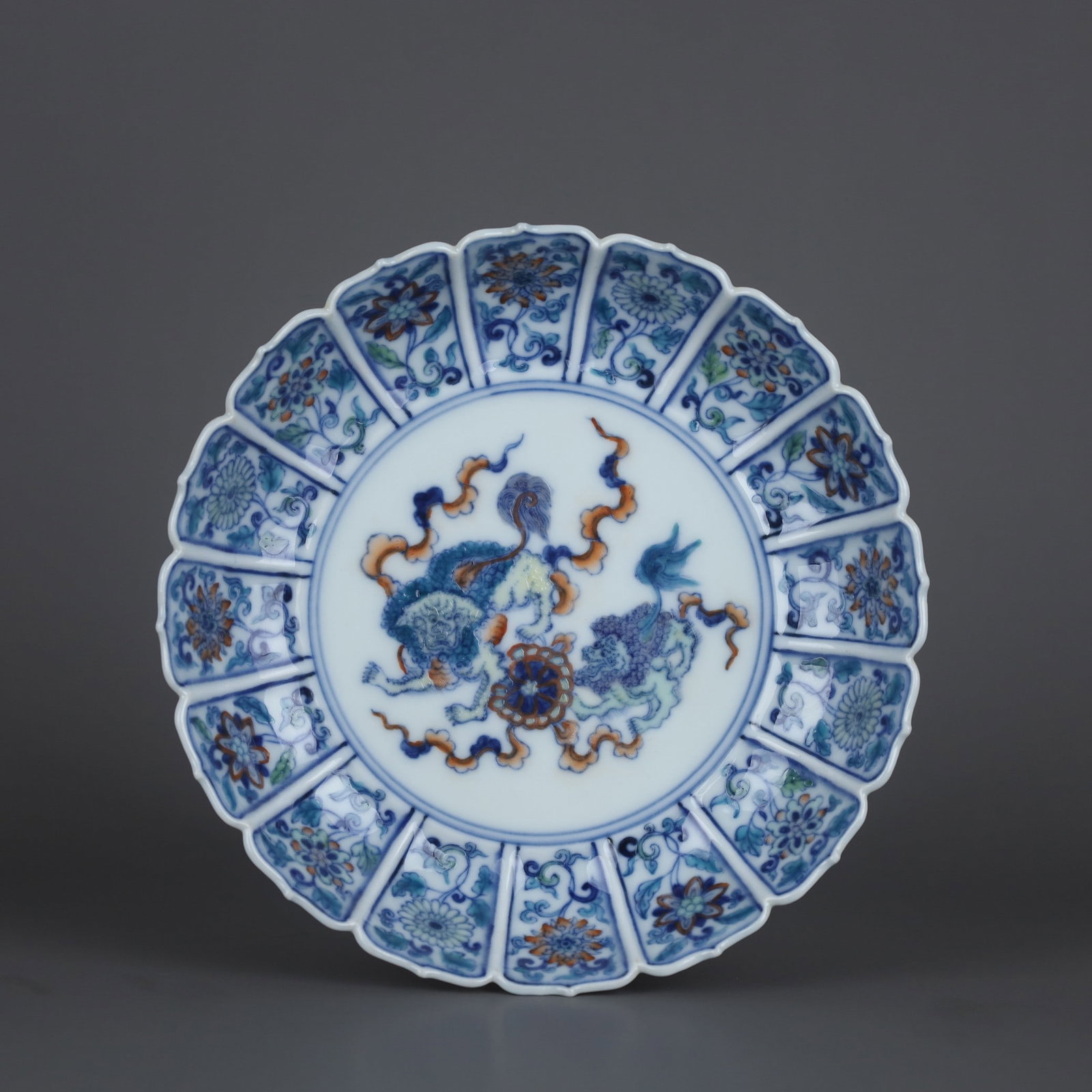 A plate with a decorative mouth plate featuring double lion play ball patterns made during the (1 of 9)