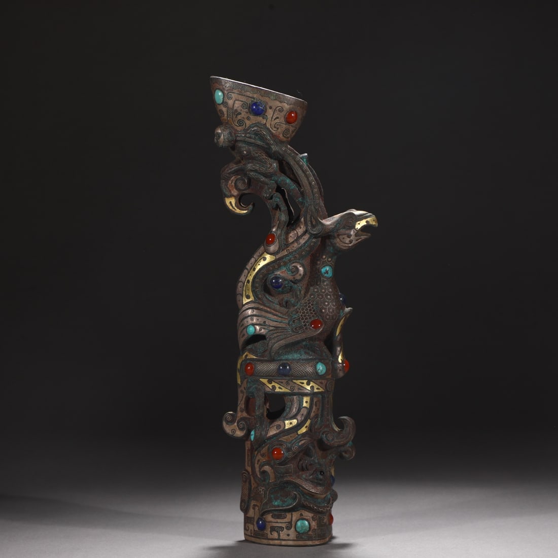 A bronze staff head from the Warring States period, inlaid with gold and silver inlaid with: A bronze staff head from the Warring States period, inlaid with gold and silver and inlaid with gemstones, shaped like a phoenix bird Size: H:30.3cm W:10.5cm W: 2 kg (The Dimensions Of All Batches Are