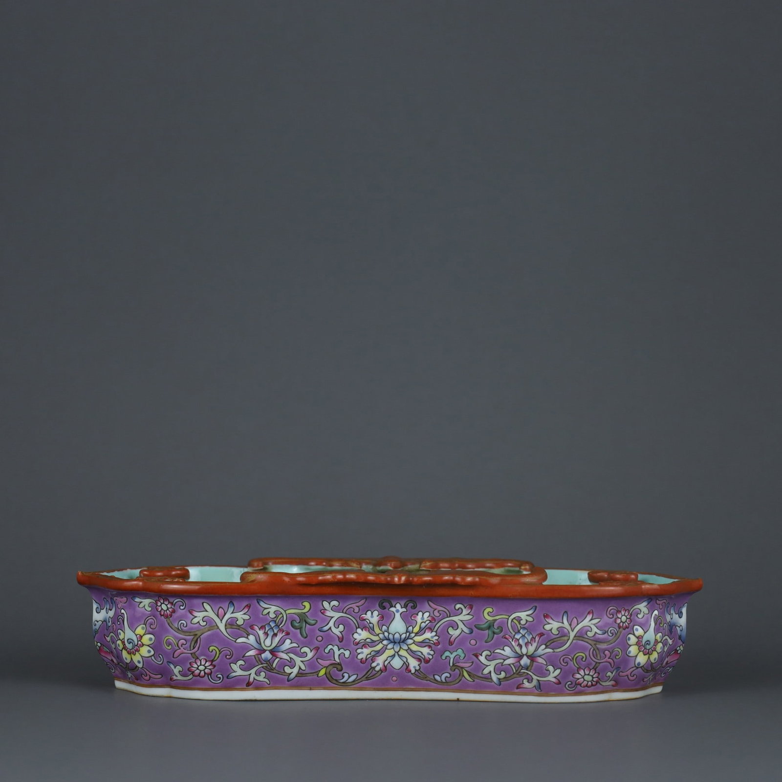 A Rouge Ground Pastel Floral Bat Brush Washer from the Qianlong Period of the Qing Dynasty: A rouge-red famille rose brush washer with entwined floral bat motifs made during the Qianlong period of the Qing Dynasty Size: H:4.5cm L: 21.2cm W:8.2cm (The Dimensions Of All Batches Are Manually Me