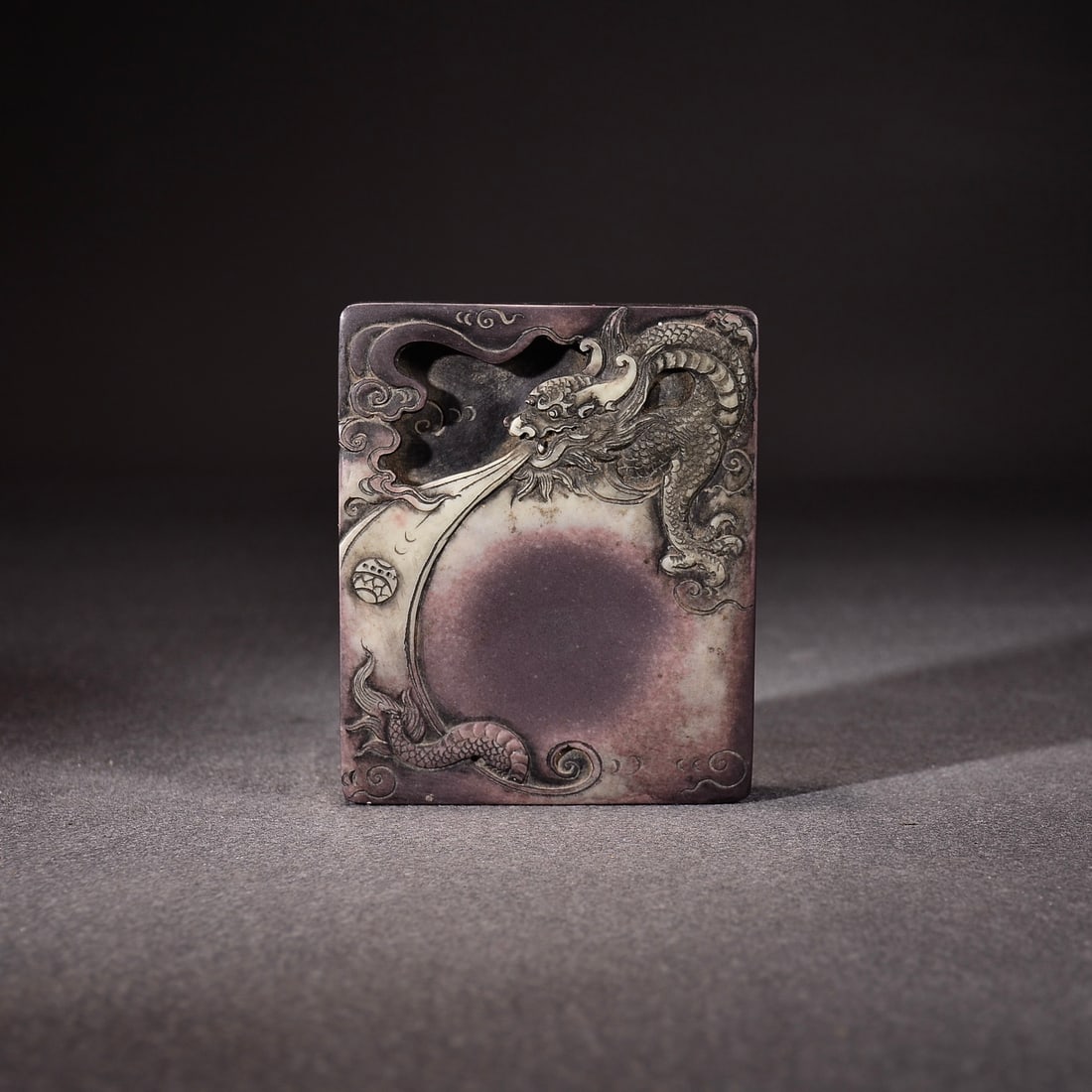 A delicate inkstone with a purple robe and jade belt featuring a flying dragon playing with a pearl (1 of 9)