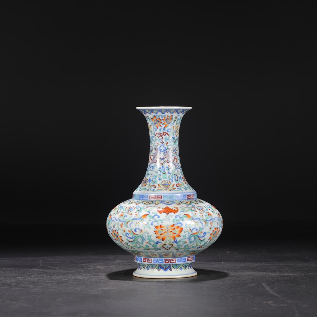 A grand appreciation vase from the Qianlong period of the Qing Dynasty, featuring colorful entwined: A grand appreciation vase with doucai entwined branches and floral patterns made during the Qianlong period of the Qing Dynasty Size: H: 23.5 cm Calibre: 7.5 cm Belly diameter: 16 cm (The Dimensions O