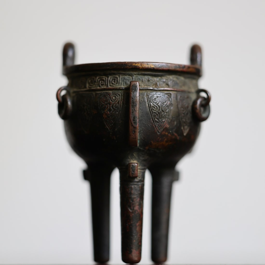 A Ming Dynasty bronze carved small tripod-shaped burner with ancient patterns (1 of 9)