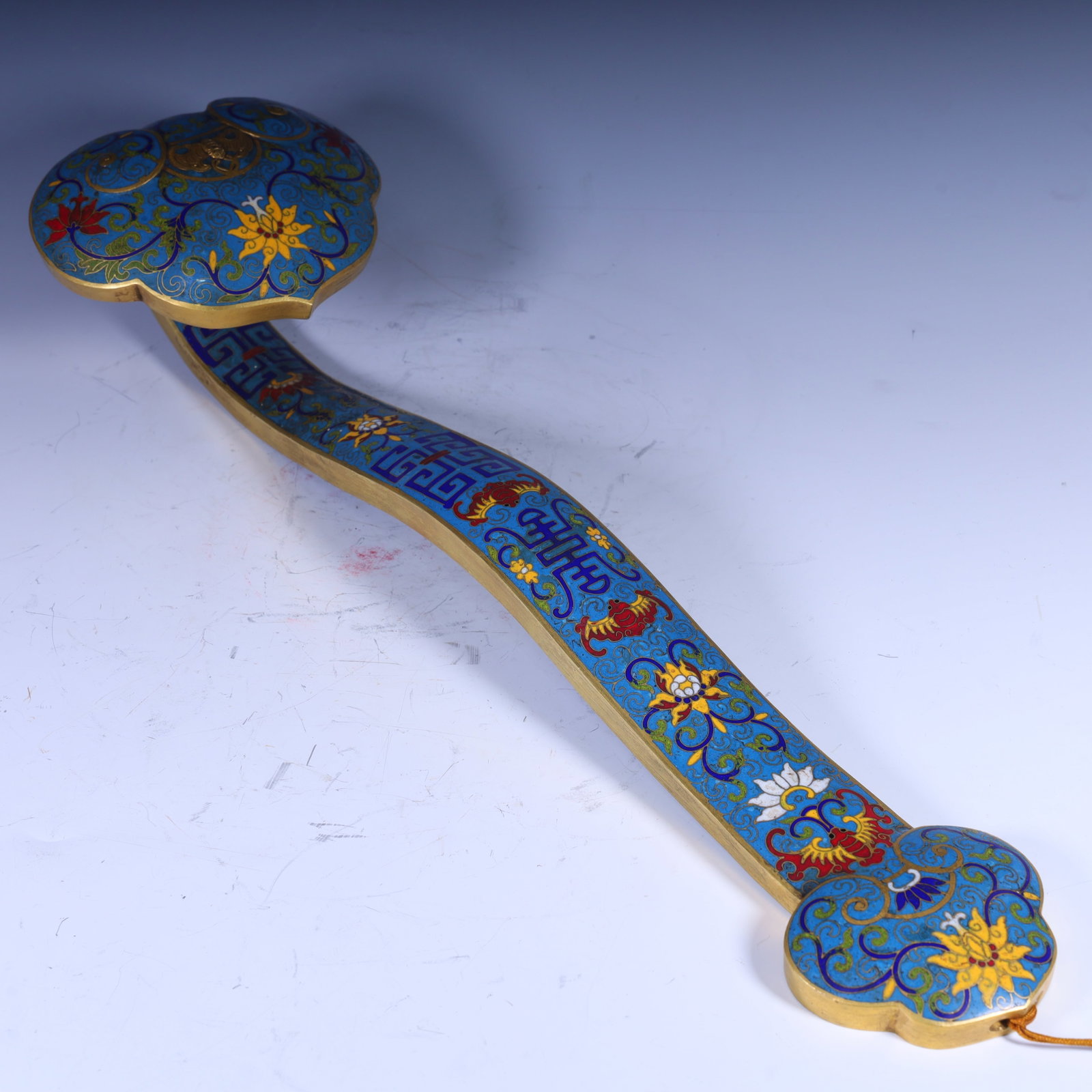 A Qing Dynasty cloisonne enamel engraved with a lucky beast pattern and a ruyi scepter: In the Qing dynasty, cloisonne enamel carved with auspicious beast patterns was used to decorate Ruyi Size:H:9.5cm L: 48cm W:14cm W:2.7kg (The Dimensions Of All Batches Are Manually Measured.If You