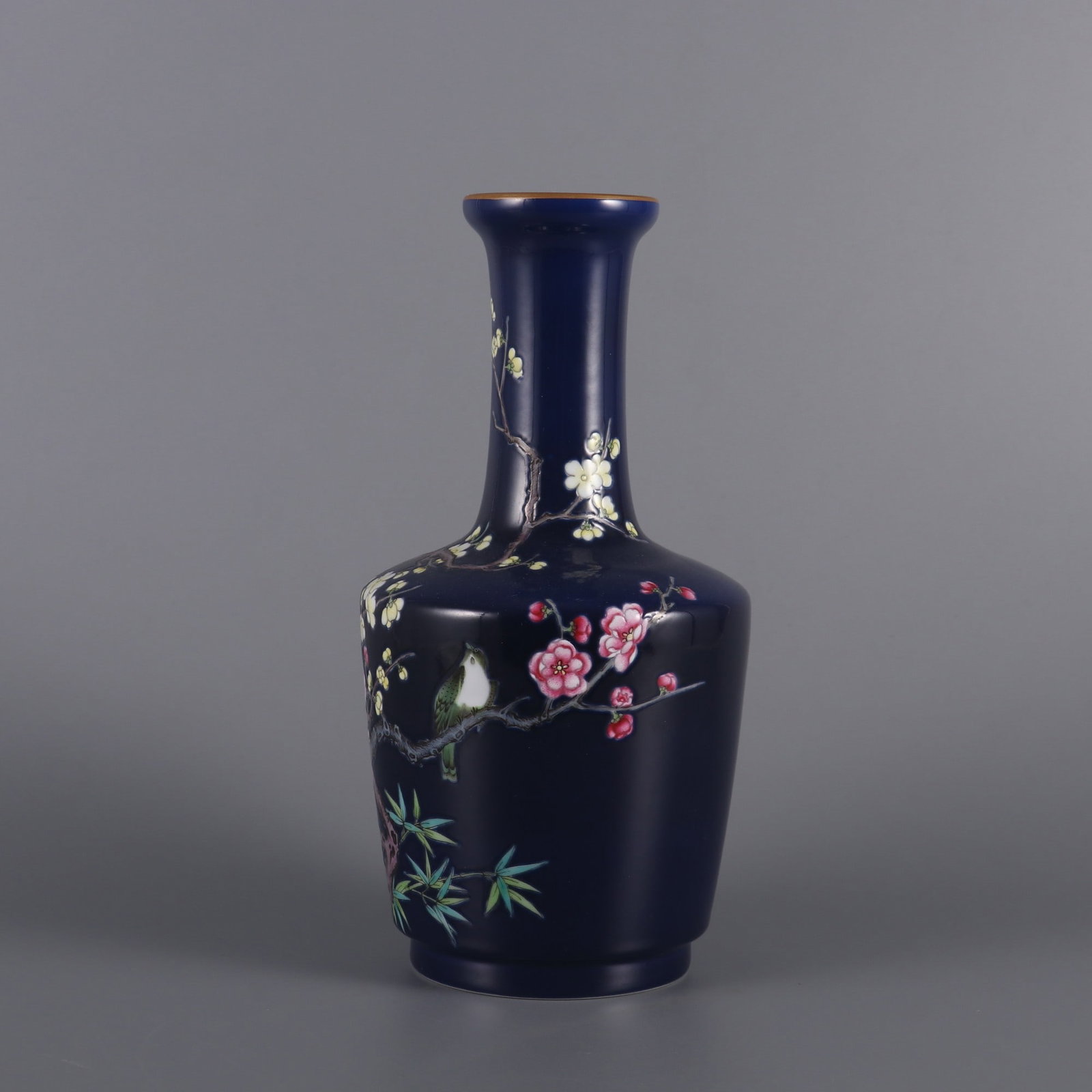A Qing Dynasty blue-ground enamel vase with colorful plum sparrows competing in spring: Qing Dynasty blue-ground enamel colorful plum sparrow 'Spring Competition' stick vase Size:H:21.5cm Belly diameter:10.5cm Calibre:5.2cm (The Dimensions Of All Batches Are Manually Measured.If You Need