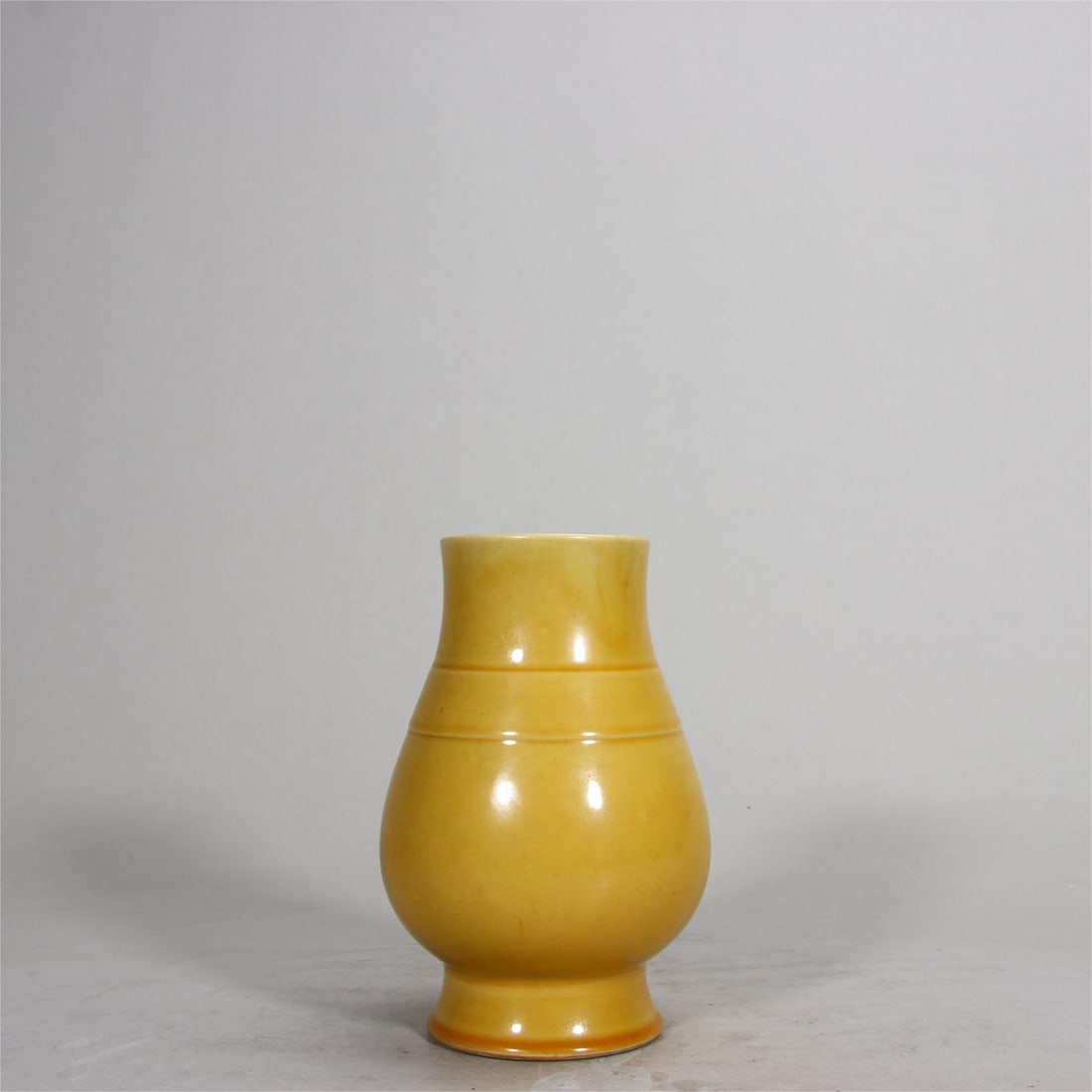 A Qing Dynasty poured yellow-glazed pipa zun: A Qing dynasty poured yellow-glazed pipa zun Size:H:12.9cm (The Dimensions Of All Batches Are Manually Measured.If You Need More Detailed Information, Please Contact Our Customer Service Before Biddin