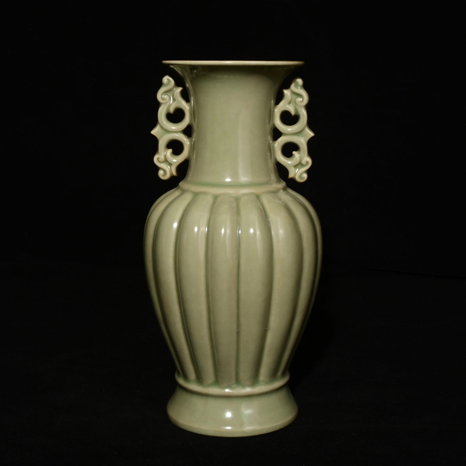A Song Dynasty Longquan Kiln Double-Handled Vase with Melon Ridges: A melon-ridge double-handled vase from the Longquan kiln of the Song Dynasty Size:23.5x12cm (The Dimensions Of All Batches Are Manually Measured.If You Need More Detailed Information, Please Contact O