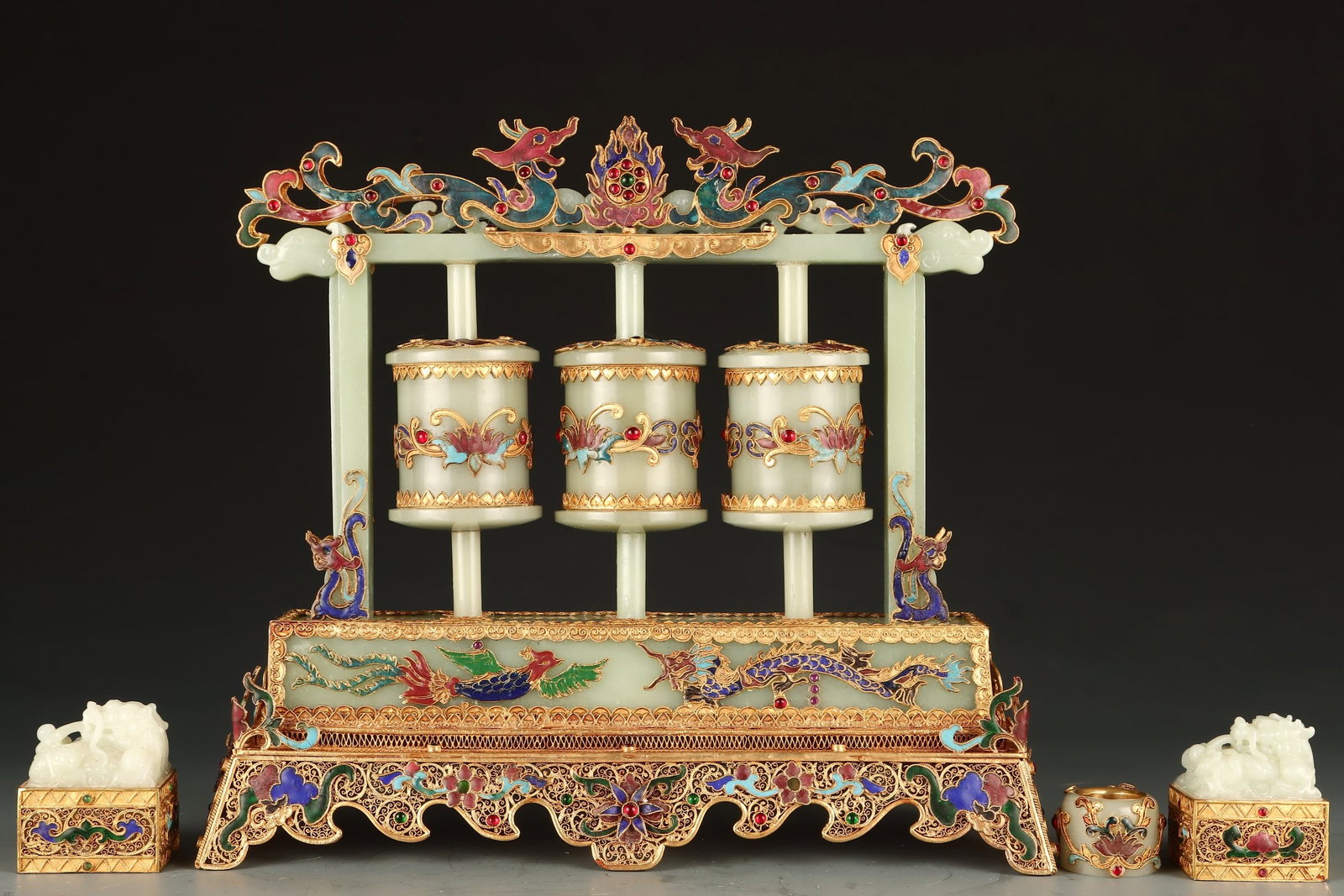 A set of exquisite Hetian jade prayer wheels: Exquisite Hetian jade prayer wheel Size: H: 28.5 cm x L: 31 cm x T: 10 cm W: 2.758 kg seal:L: 5 cm x T: 4.5 cm x H: 6 cm W: 0.3 kg fingerboard:H: 3 cm x T: 3.5 cm W: 0.057 kg (The Dimensions Of All Ba