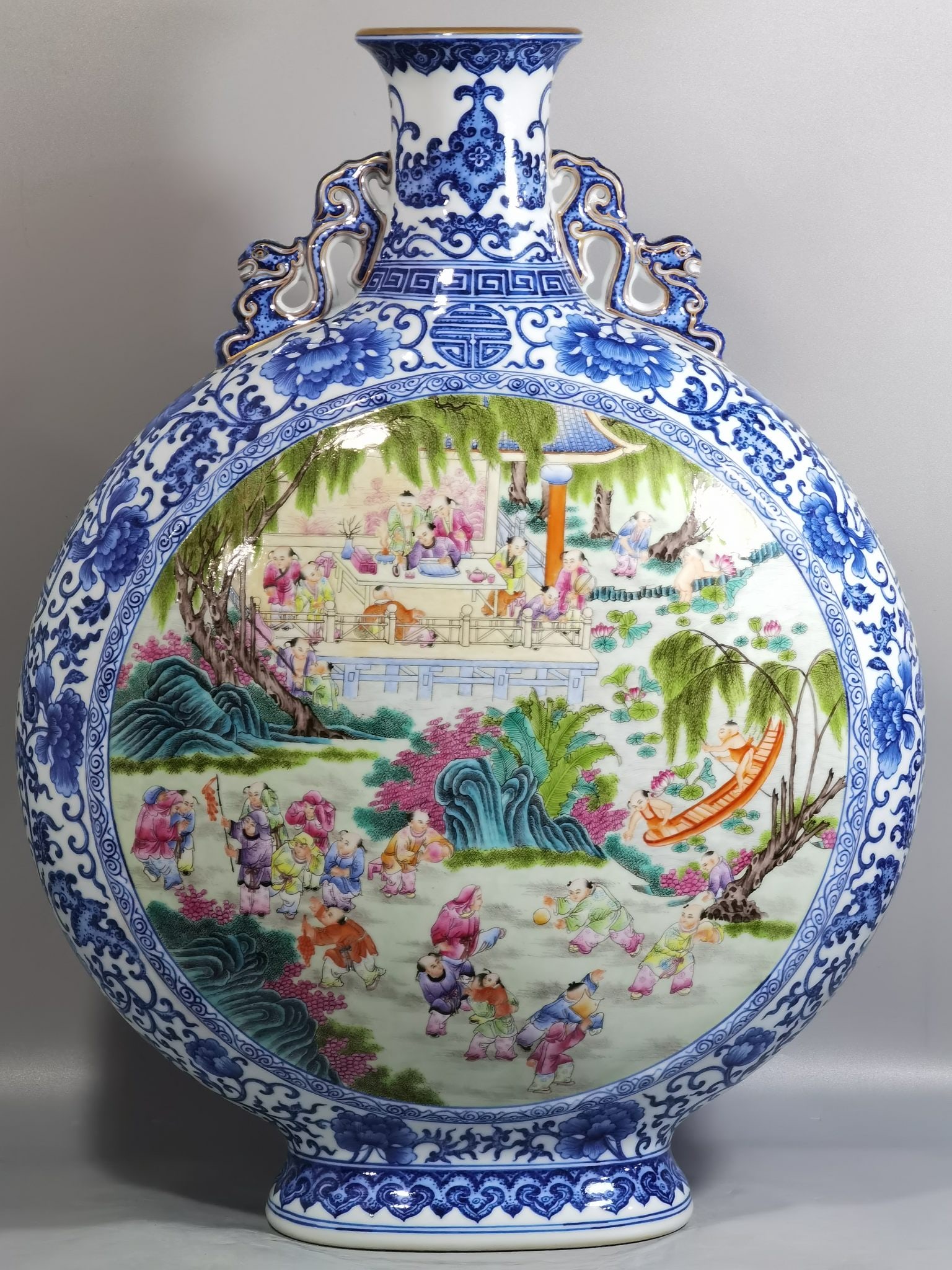 A delicate blue-and-white entwined lotus with window and famille rose hundred petals with double: Exquisite blue-and-white entwined lotus with open windows, famille rose hundred zi painting, double-handled flat vase embracing the moon Size: H: 58 cm x D: 43 cm (The Dimensions Of All Batches Are Ma